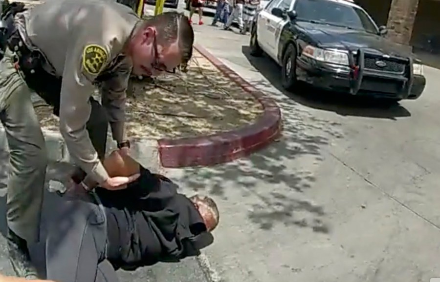 FILE - In this image taken from police body camera footage provided by Los Angeles Sheriff's office, a Sheriff's deputies arrests a couple in a grocery store parking lot in Lancaster, Calif., on June 24, 2023. (Los Angeles County Sheriff's Office via AP, File)