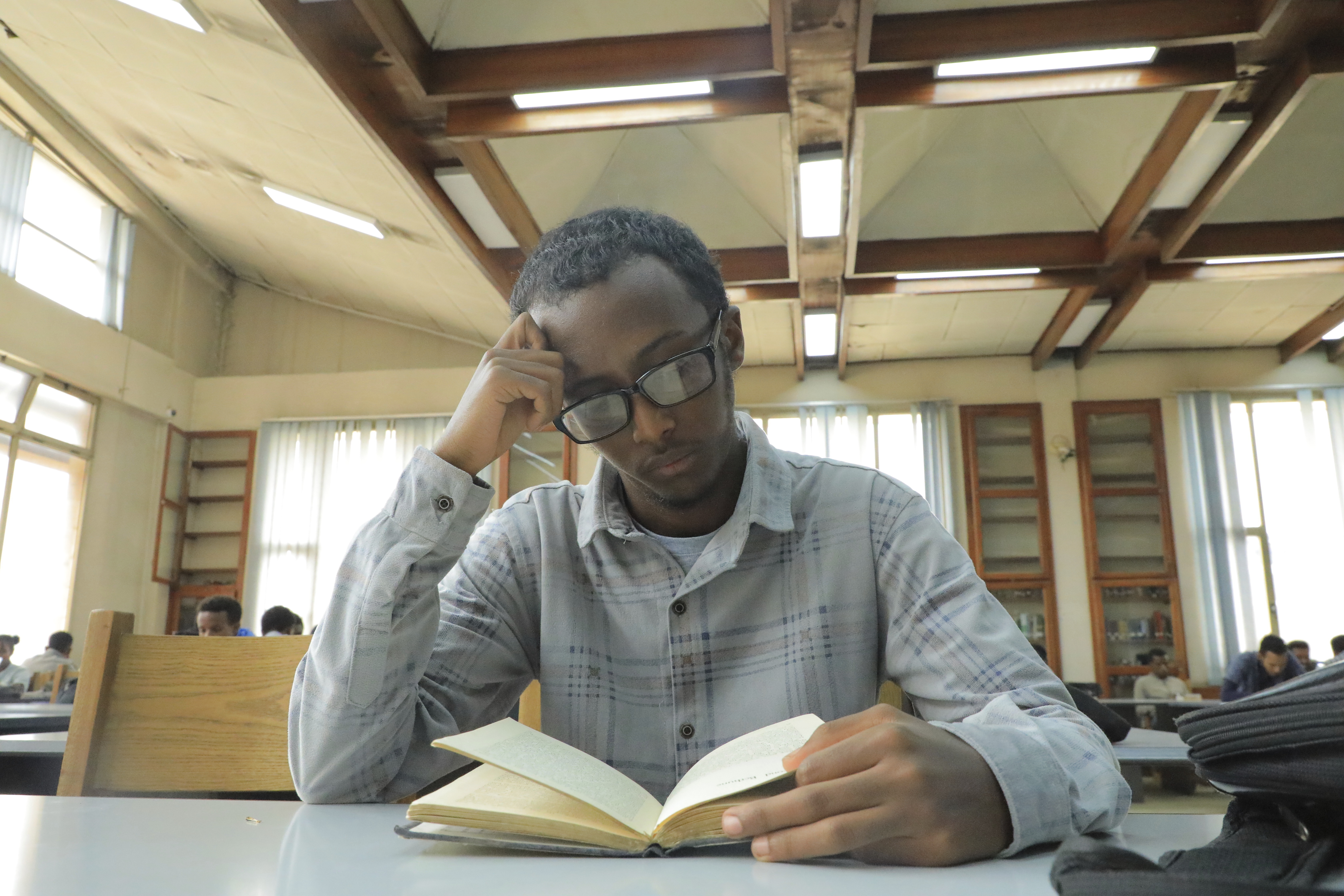 Yonas Nuguse, 21 years old, reads a book at Wemezeker National Library in Addis Ababa, Ethiopia Friday, May 30, 2025. (AP Photo/Amanuel Birhane)