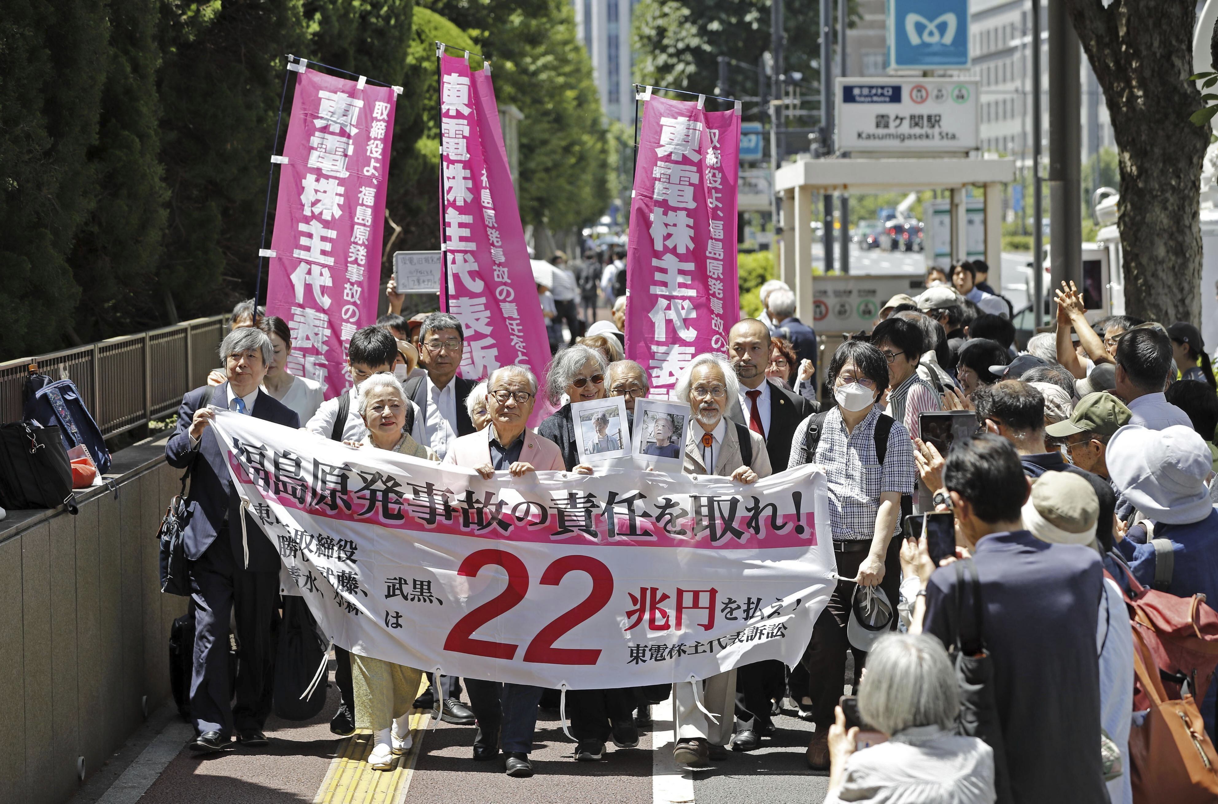 Plaintiffs march into the Tokyo High Court for a ruling on former executives of the Tokyo Electric Power Company Holdings' accountabilities for the 2011 meltdown crisis, at the Tokyo court Friday, June 6, 2025. (Masanori Kumagai/Kyodo News via AP)