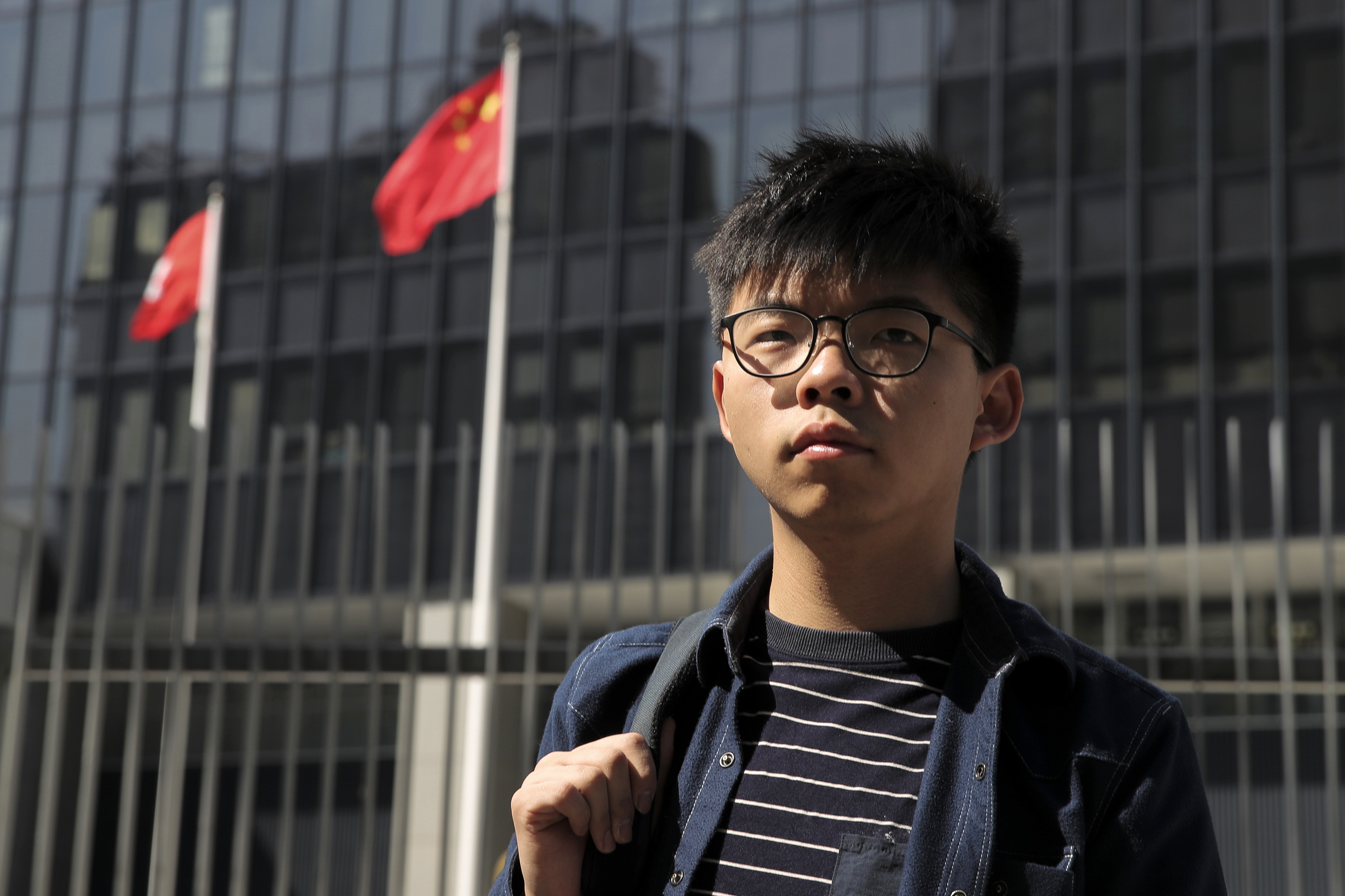 FILE - Pro-democracy activist Joshua Wong stands outside the Legislative Council building in Hong Kong, Thursday, Nov. 28, 2019.(AP Photo/Kin Cheung, File)