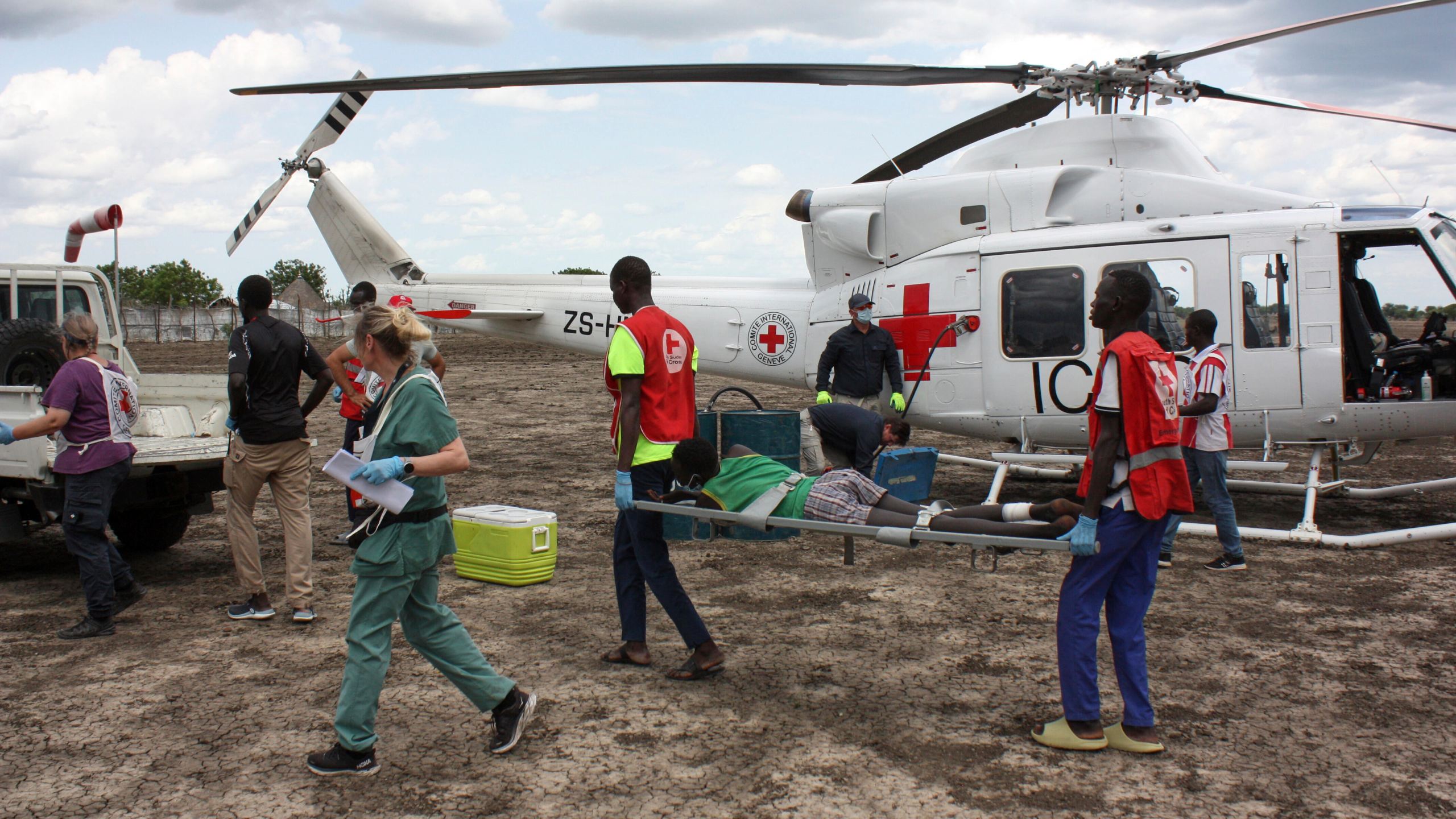 FILE - Medical staff with the International Committee of the Red Cross (ICRC) and South Sudan Red Cross, move a wounded patient to an ambulance in Akobo, South Sudan, Saturday, May 24, 2025. (AP Photo/Joseph Falzetta, file)