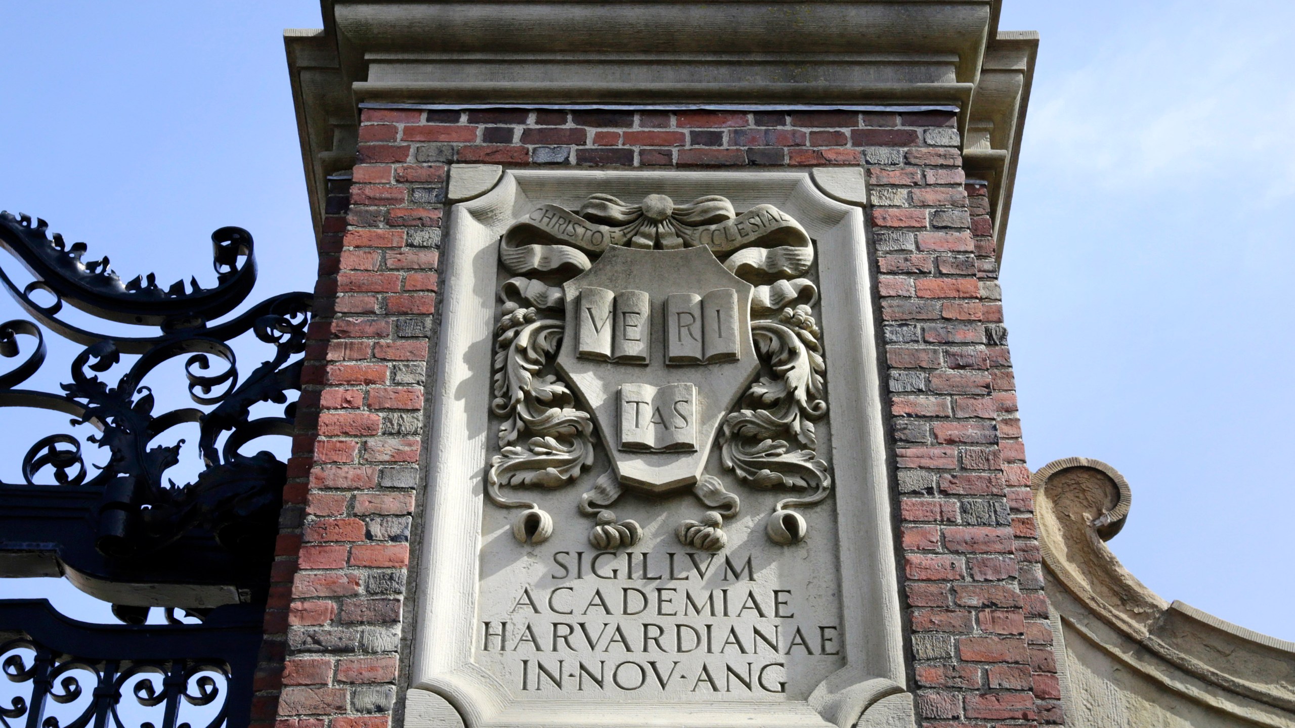 FILE - A relief sculpture rests on a gate to the entrance of Harvard University, in Cambridge, Mass., March 13, 2016. (AP Photo/Steven Senne, File)