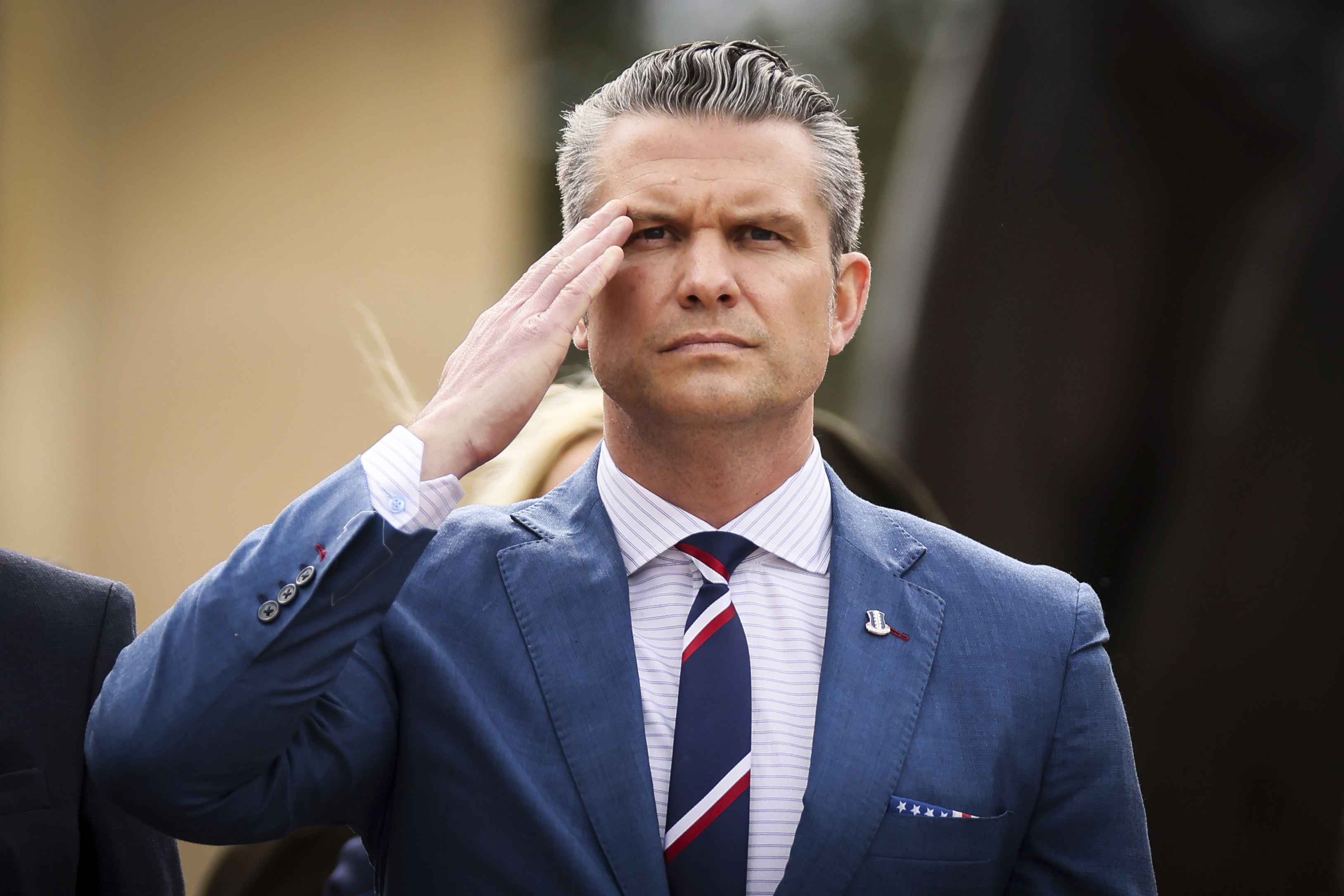 U.S. Defense Secretary Pete Hegseth salutes during a ceremony at the US cemetery to commemorate the 81st anniversary of the D-Day landings, Friday, June 6, 2025 in Colleville-sur-Mer, Normandy. (AP Photo/Thomas Padilla)