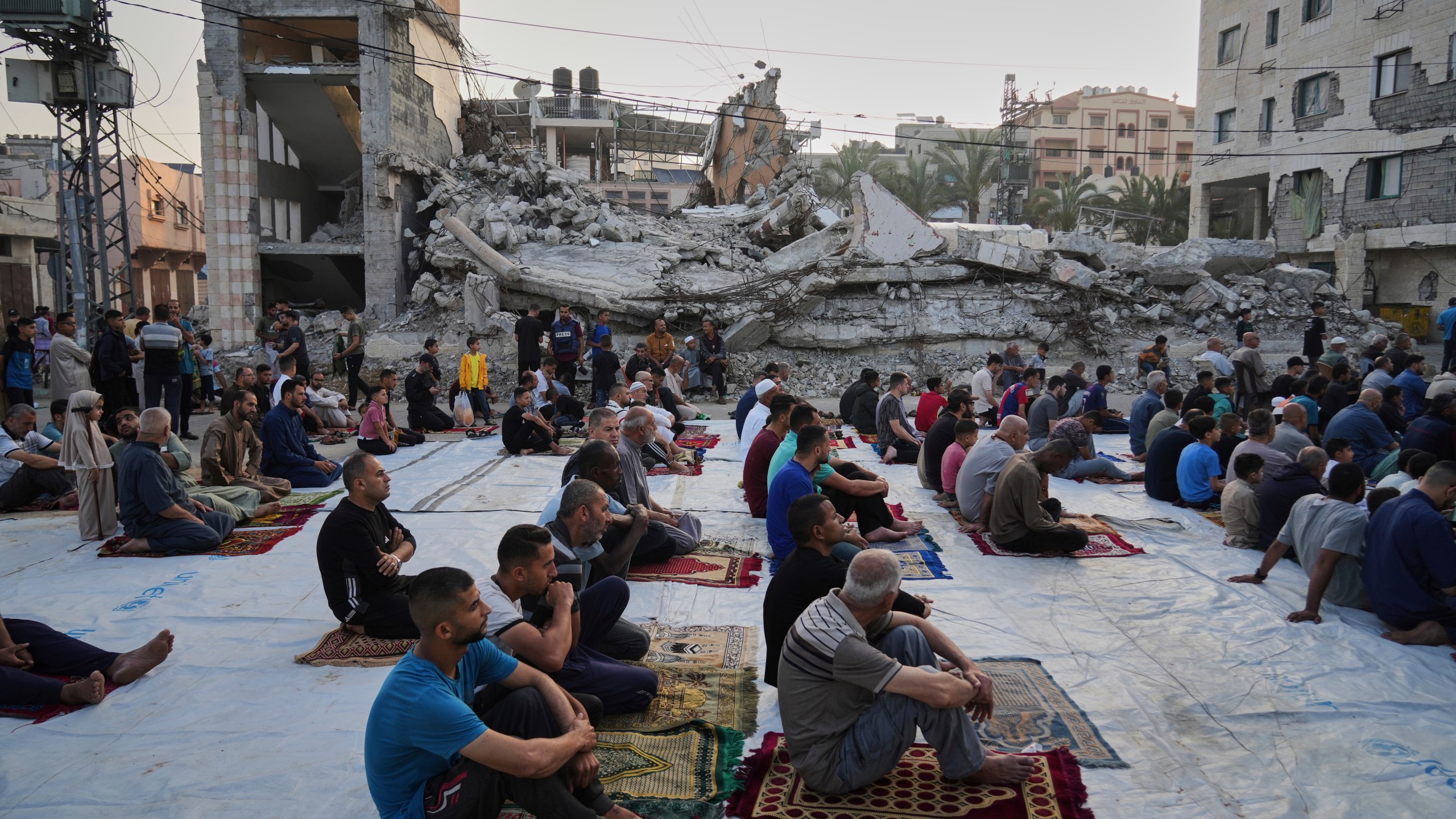 Palestinians gather for Eid al-Adha prayers beside the ruins of a mosque destroyed by Israeli bombardment, in Deir al-Balah, Gaza on Friday, June 6, 2025. (AP Photo/Abdel Kareem Hana)