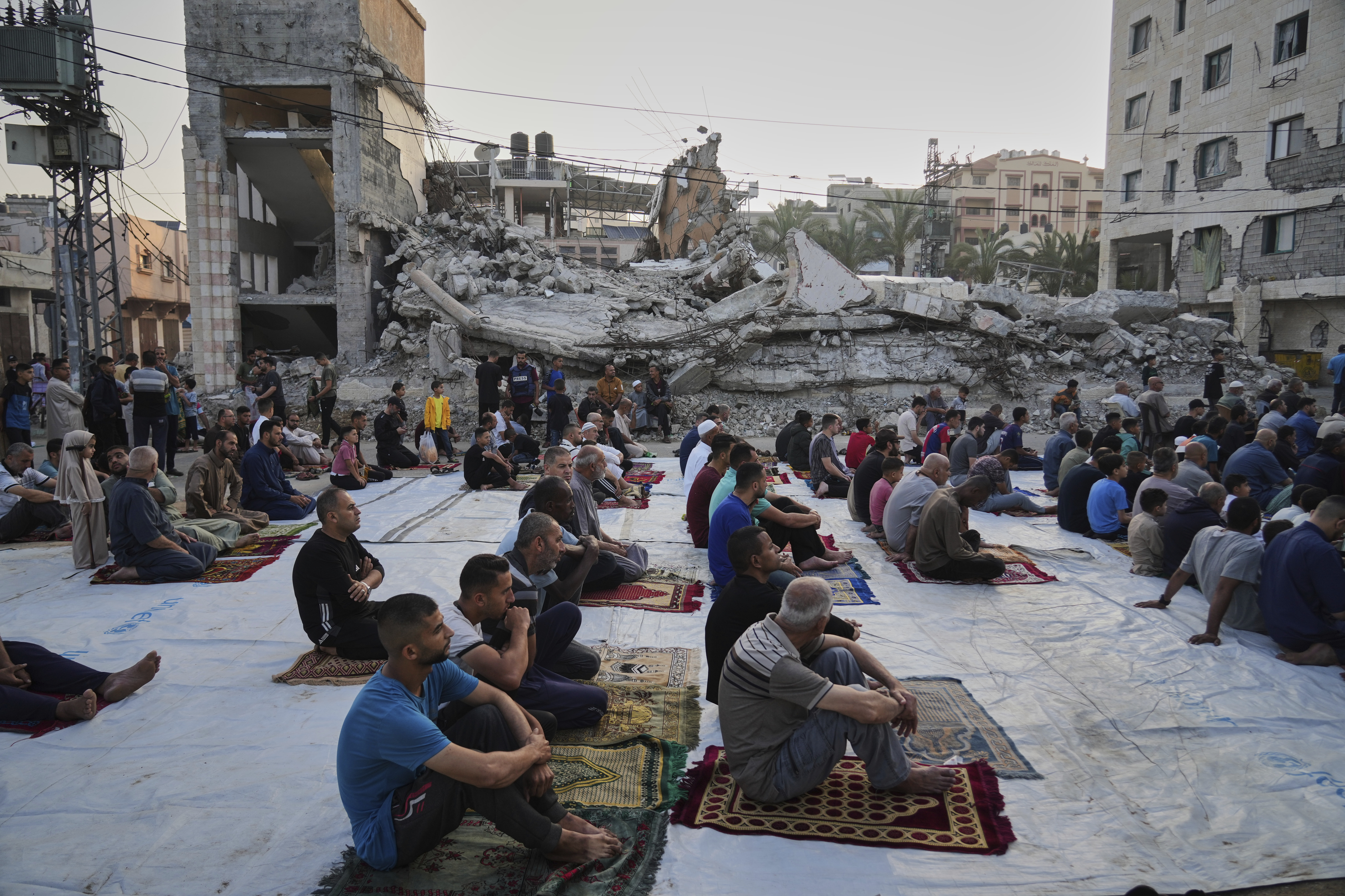 Palestinians gather for Eid al-Adha prayers beside the ruins of a mosque destroyed by Israeli bombardment, in Deir al-Balah, Gaza on Friday, June 6, 2025. (AP Photo/Abdel Kareem Hana)