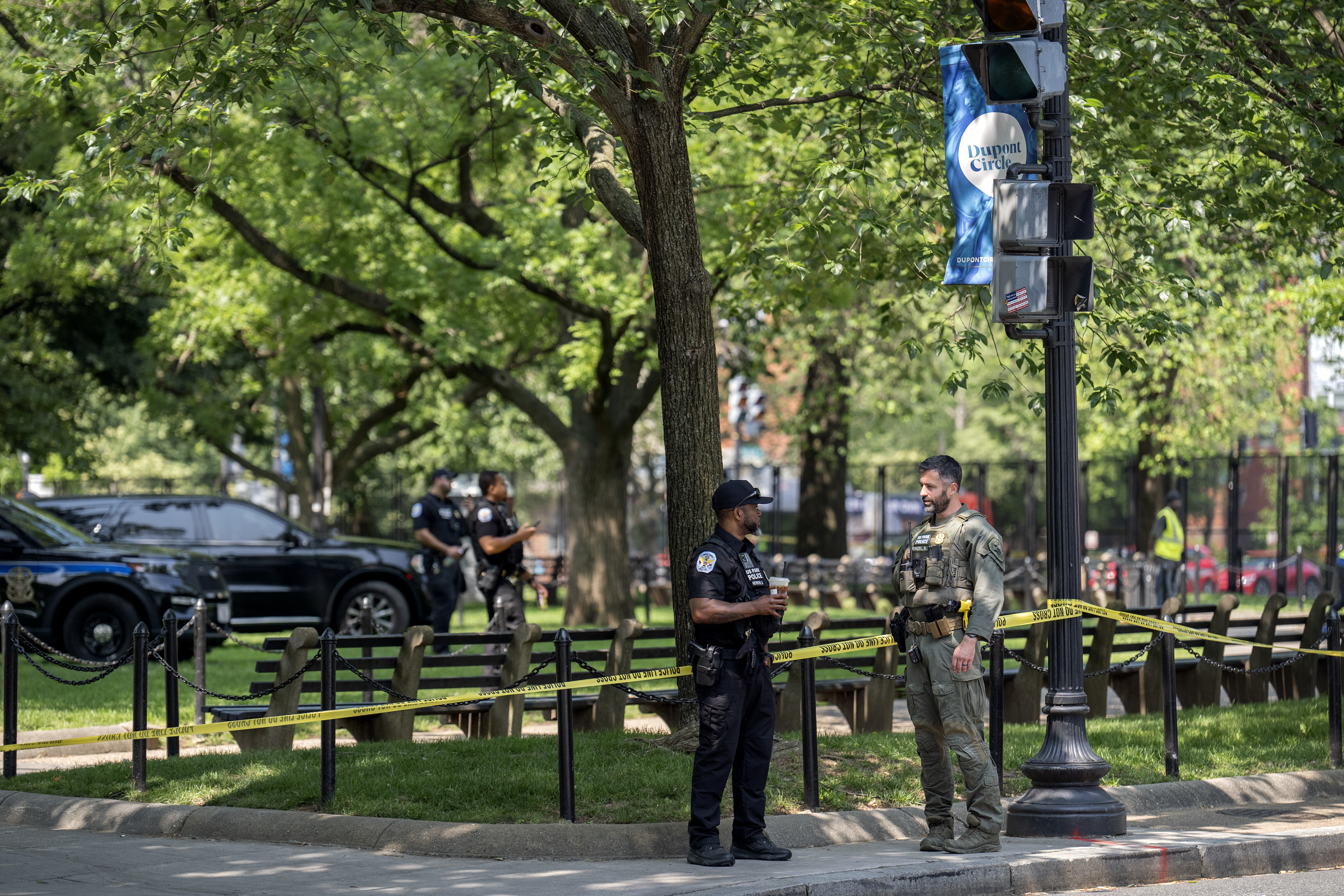 U.S. Park Police stand by as workers put up fencing around Dupont Circle ahead of the World Pride Parade, Friday, June 6, 2025, in Washington. (AP Photo/Mark Schiefelbein)