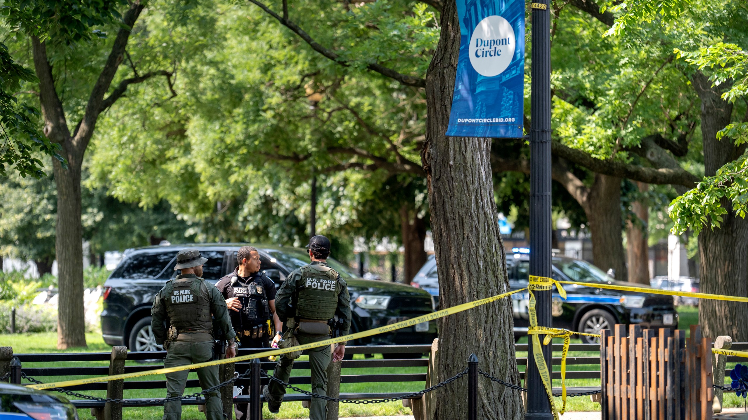 U.S. Park Police stand by as workers put up fencing around Dupont Circle ahead of the World Pride Parade, Friday, June 6, 2025, in Washington. (AP Photo/Mark Schiefelbein)