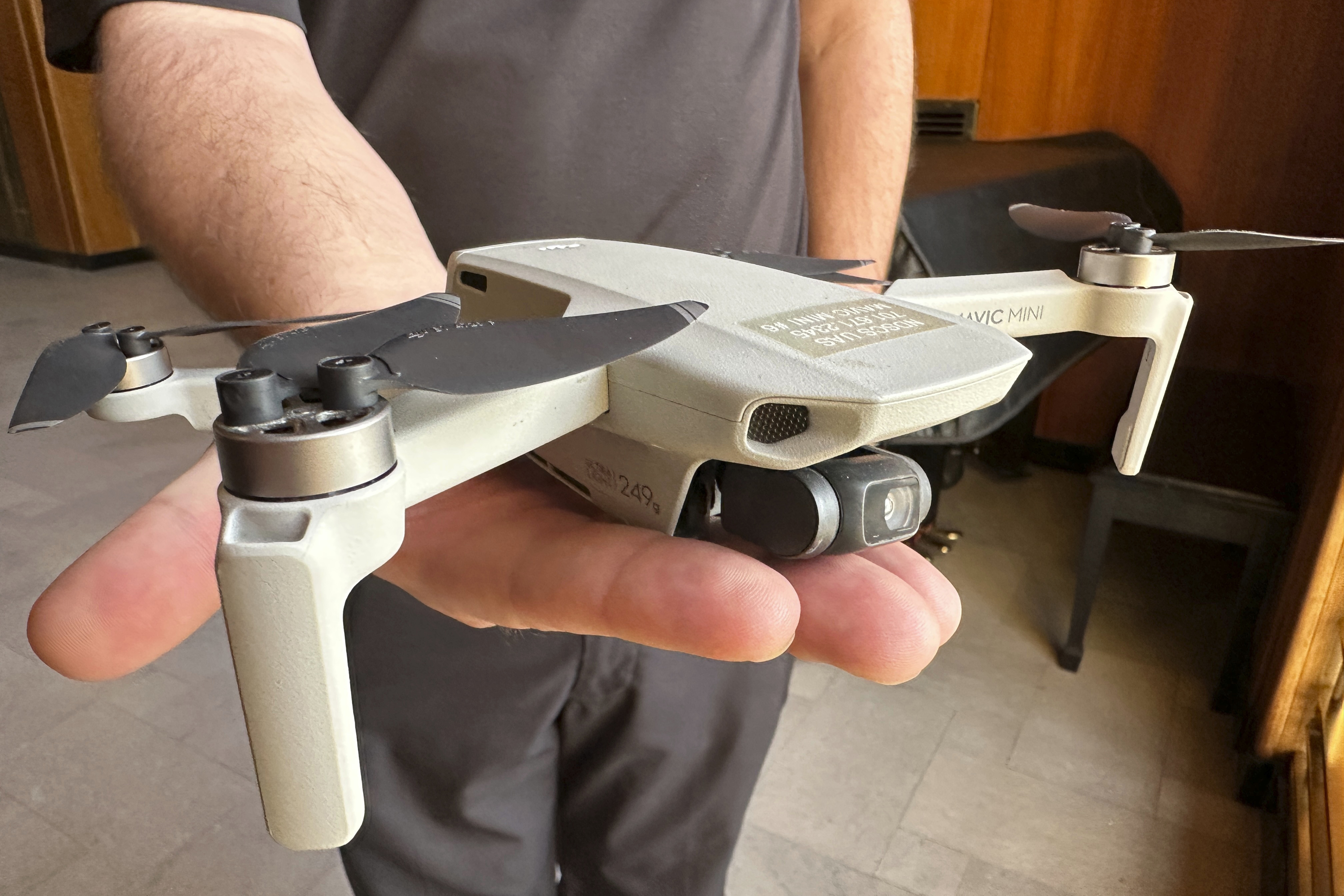 FILE - Seth Simonson, assistant professor/UAS curriculum lead for the North Dakota State College of Science, holds a Chinese-manufactured drone the college mainly uses for pilot training and photo and video collecting by students, at the state Capitol in Bismarck, N.D., on Jan. 15, 2025, (AP Photo/Jack Dura, File)