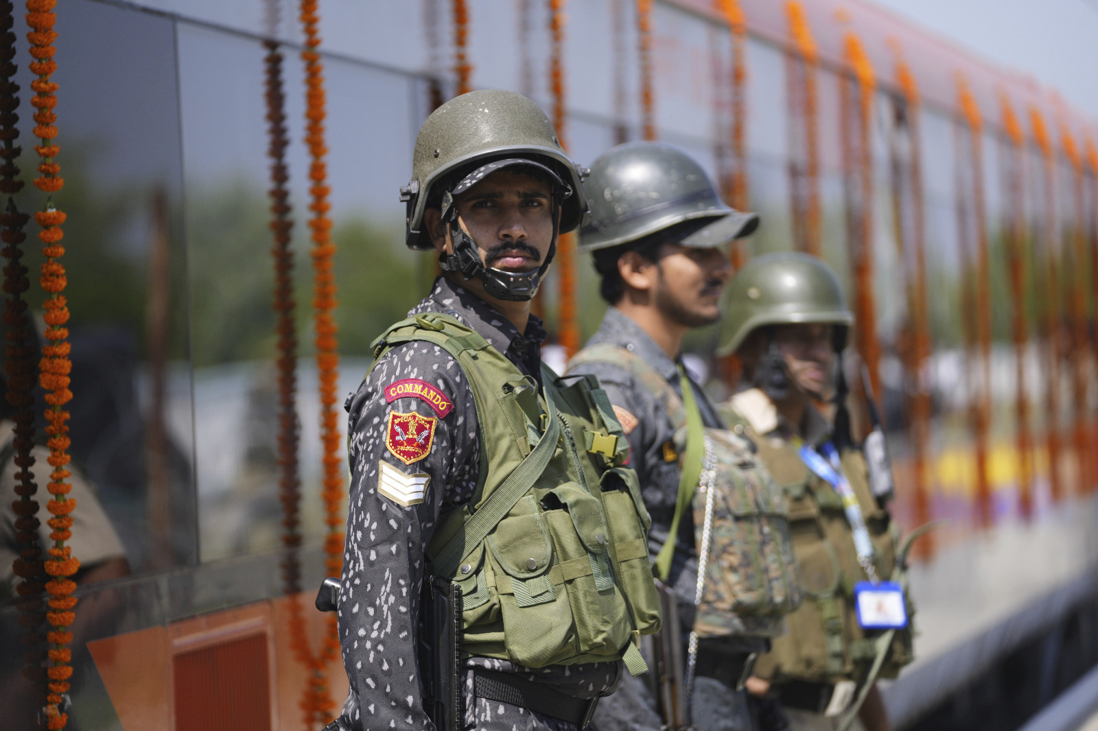 Security personnel stand guard next to Vande Bharat Express train which is soon to be inaugurated to run between Srinagar and Katra, in Srinagar, Indian controlled Kashmir, Friday, June 6, 2025. (AP Photo/Dar Yasin)