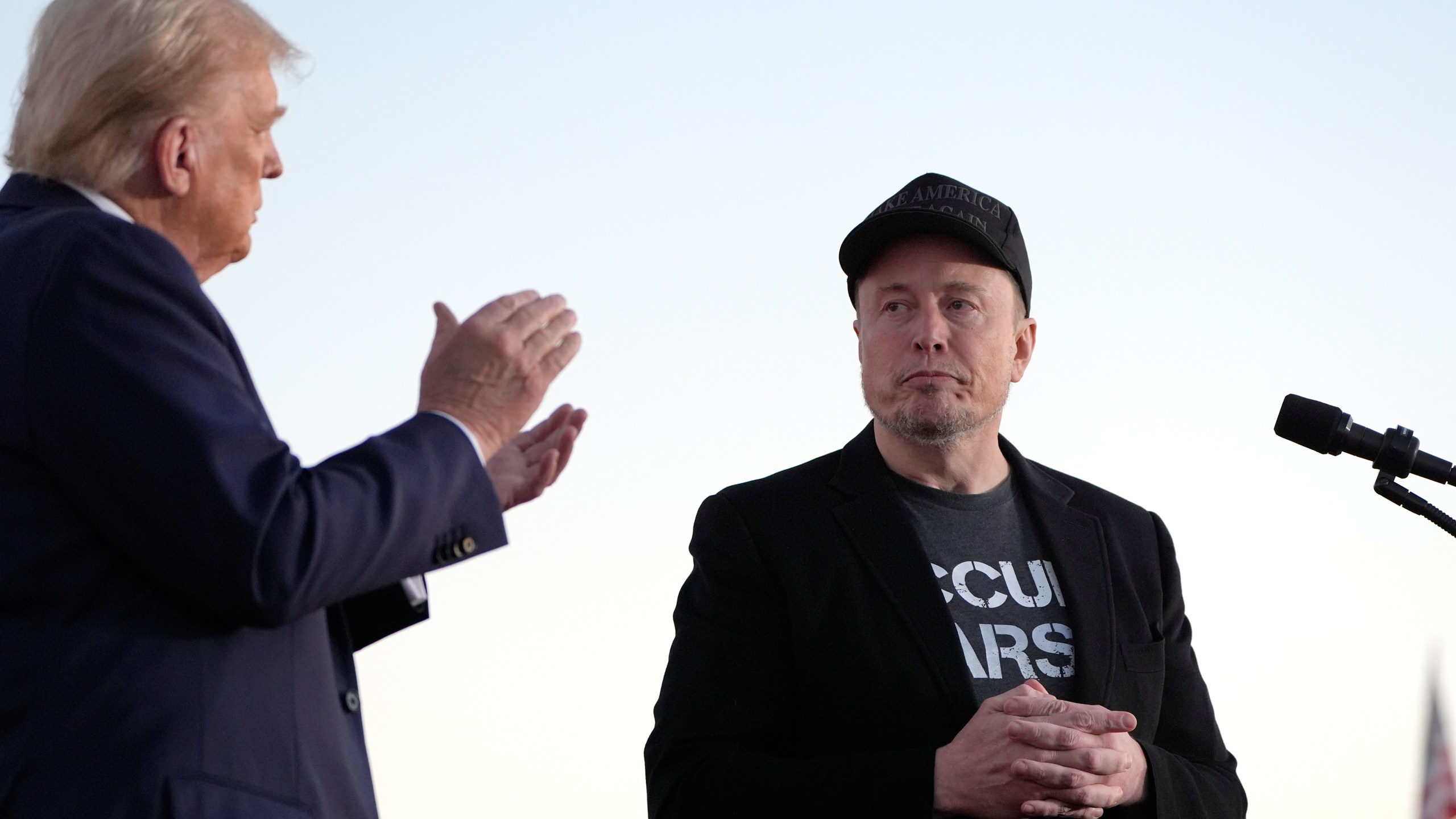 FILE - Republican presidential nominee former President Donald Trump, left, claps as Tesla and SpaceX CEO Elon Musk prepares to depart after a campaign event at the Butler Farm Show on Oct. 5, 2024, in Butler, Pa. (AP Photo/Alex Brandon, File)