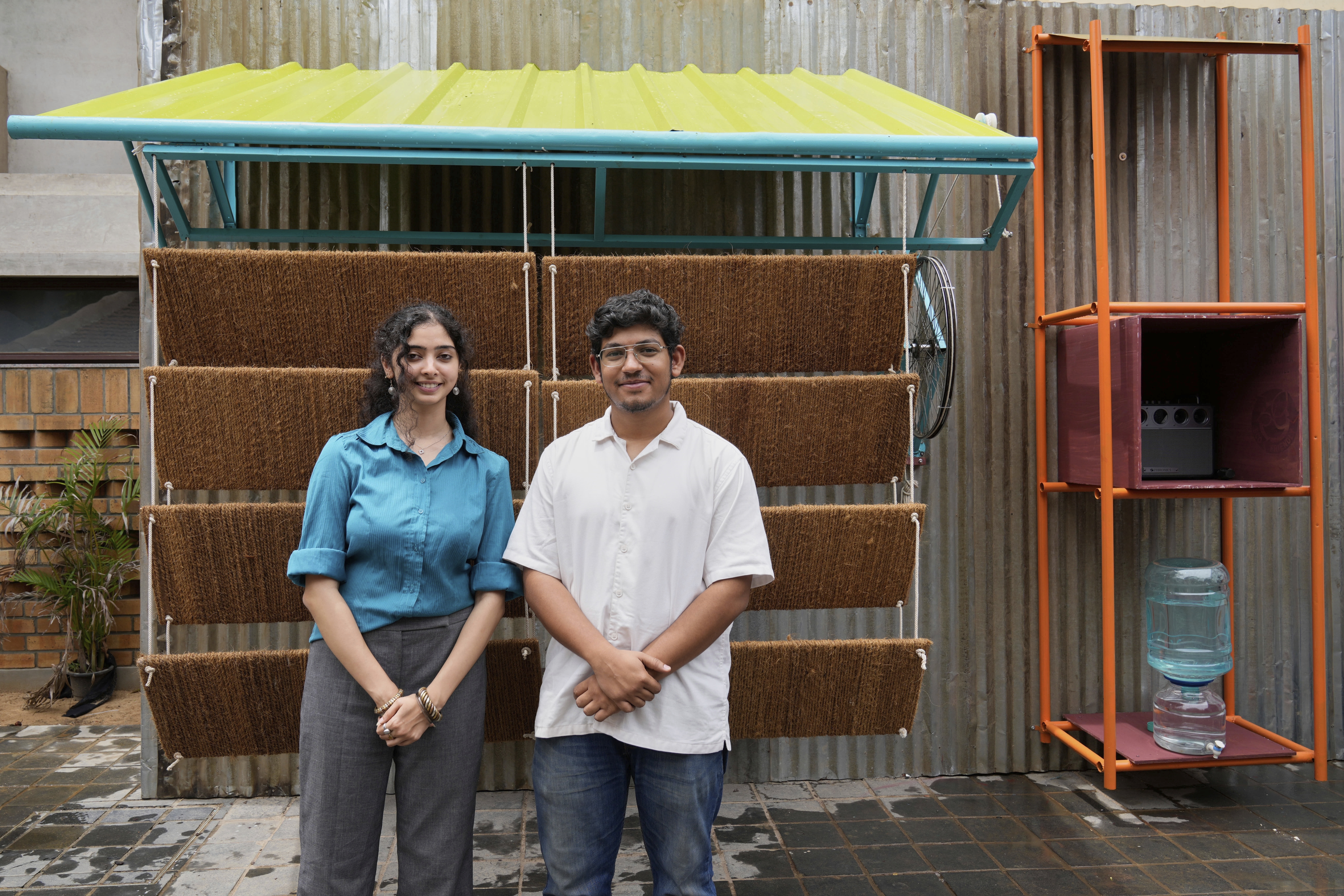 Ankritya Diggavi, left, and Sagar Kandal, architects behind the design of Neralu, an innovative portable heat shelter, pose in front of their installation at the Sweat and Concrete 2025 event in Bengaluru, India, Thursday, May 29, 2025. (AP Photo/Aijaz Rahi)