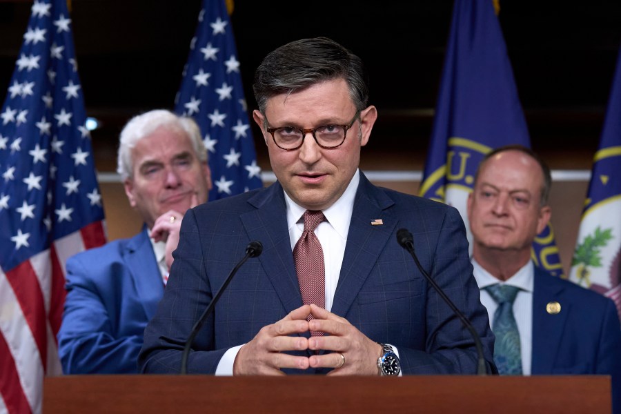 Speaker of the House Mike Johnson, R-La., flanked by Majority Whip Tom Emmer, R-Minn., left, and Rep. Mark Messmer, R-Ind., talks with reporters to discuss work on President Donald Trump's bill of tax breaks and spending cuts, at the Capitol in Washington, Wednesday, June 4, 2025. (AP Photo/J. Scott Applewhite)