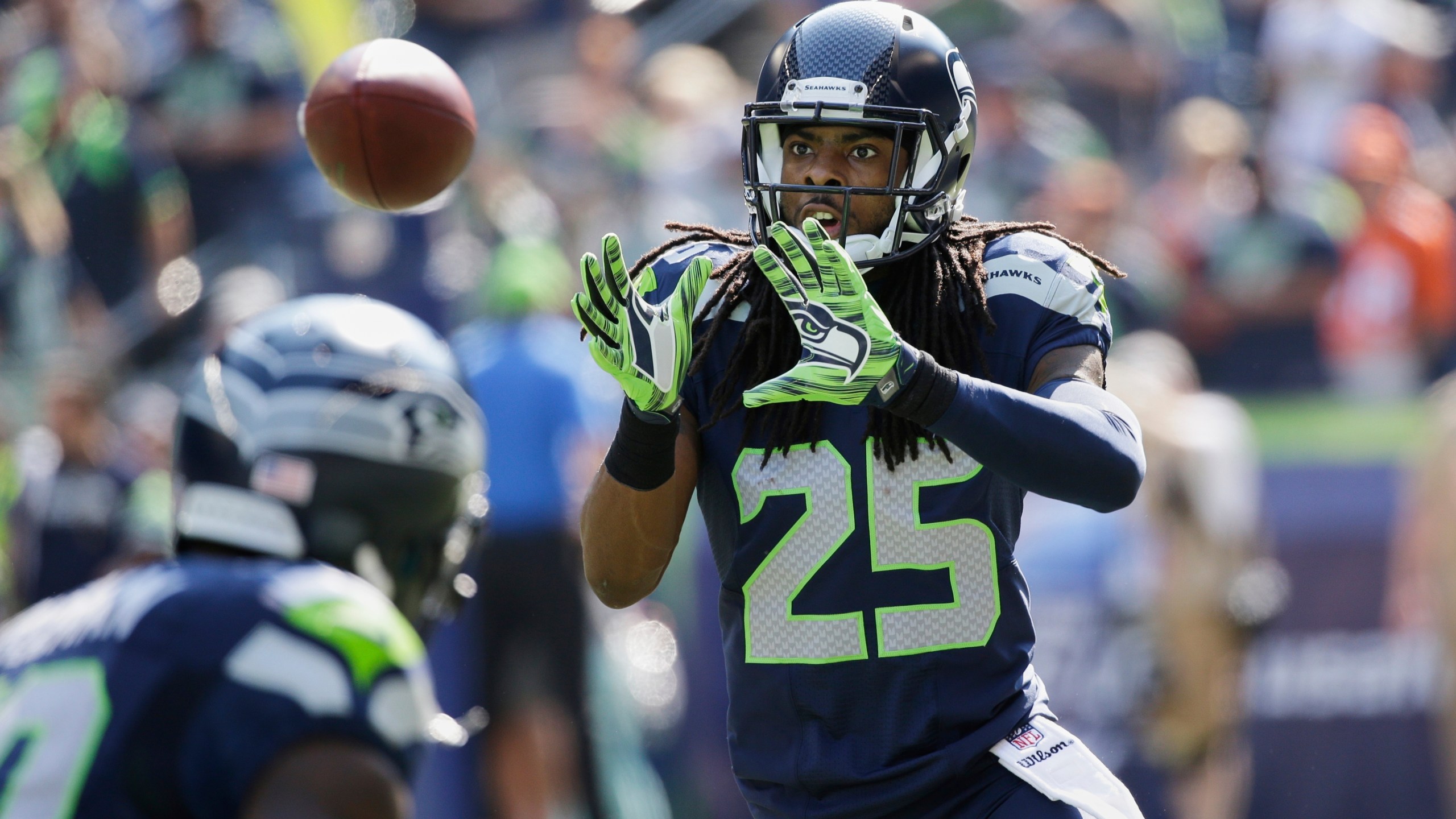 FILE - Seattle Seahawks cornerback Richard Sherman takes part in warmups before an NFL football game against the Denver Broncos, Sunday, Sept. 21, 2014, in Seattle. (AP Photo/Elaine Thompson, File)