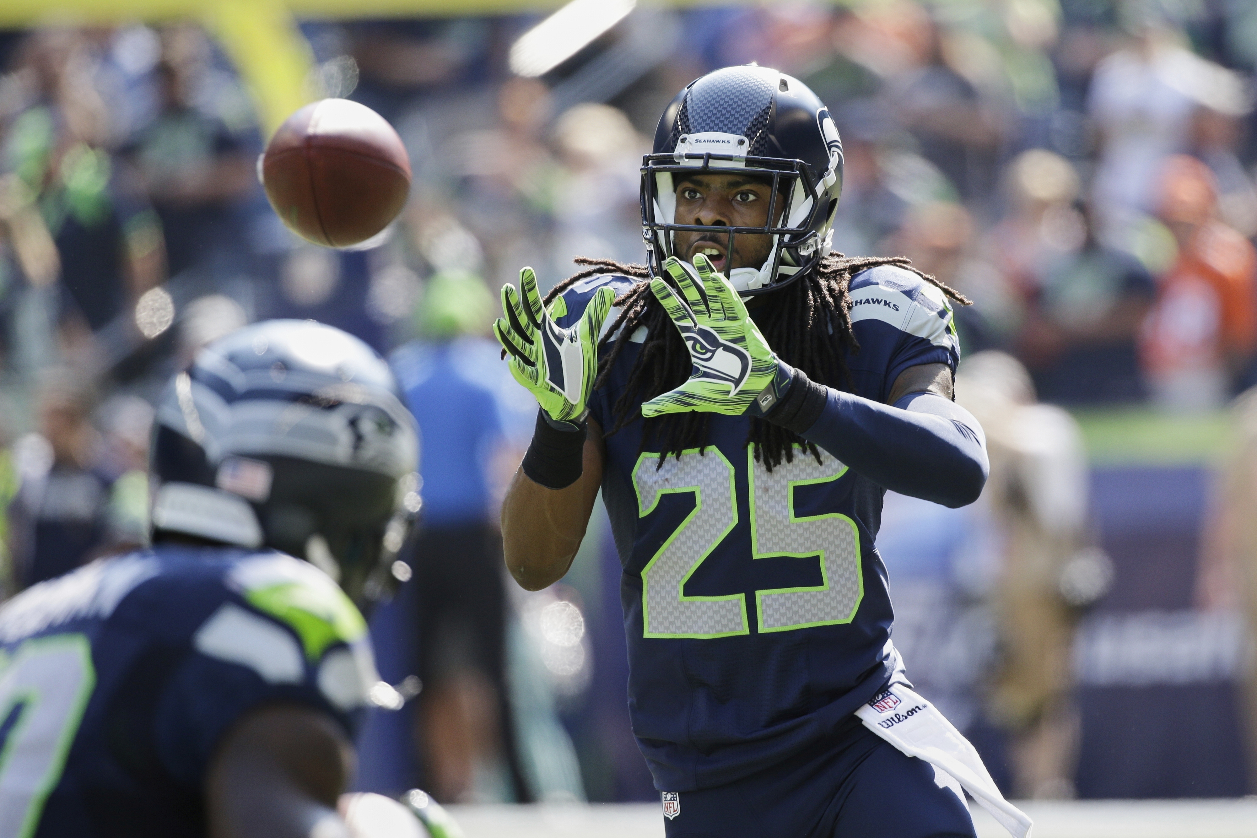 FILE - Seattle Seahawks cornerback Richard Sherman takes part in warmups before an NFL football game against the Denver Broncos, Sunday, Sept. 21, 2014, in Seattle. (AP Photo/Elaine Thompson, File)