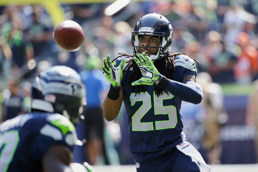 FILE - Seattle Seahawks cornerback Richard Sherman takes part in warmups before an NFL football game against the Denver Broncos, Sunday, Sept. 21, 2014, in Seattle. (AP Photo/Elaine Thompson, File)