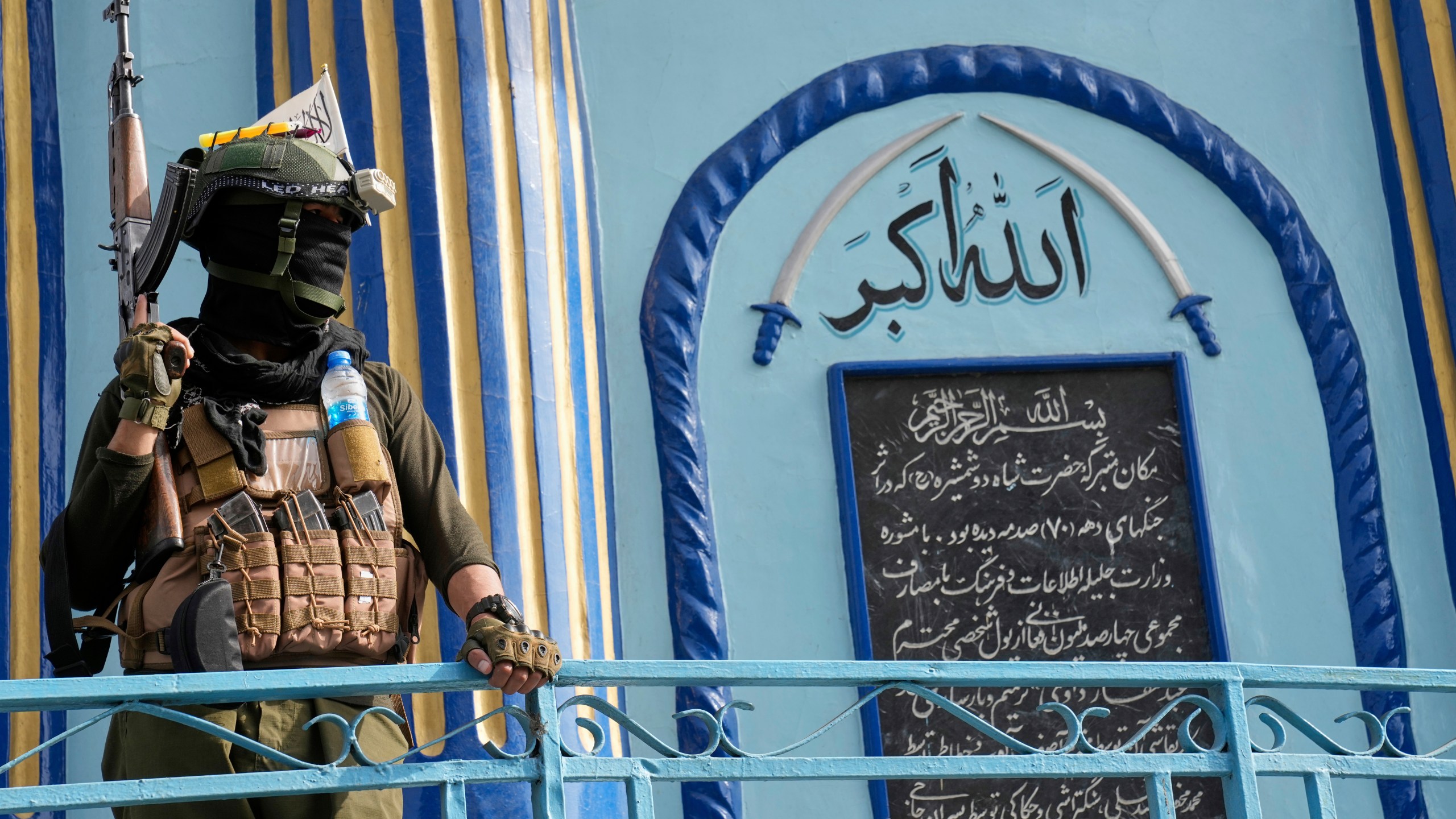 A Taliban fighter stands guard next to the Shah-Do Shamshira Mosque while people attend the Eid al-Adha prayer in Kabul, Afghanistan, Saturday, June 7, 2025. (AP Photo/Ebrahim Noroozi)