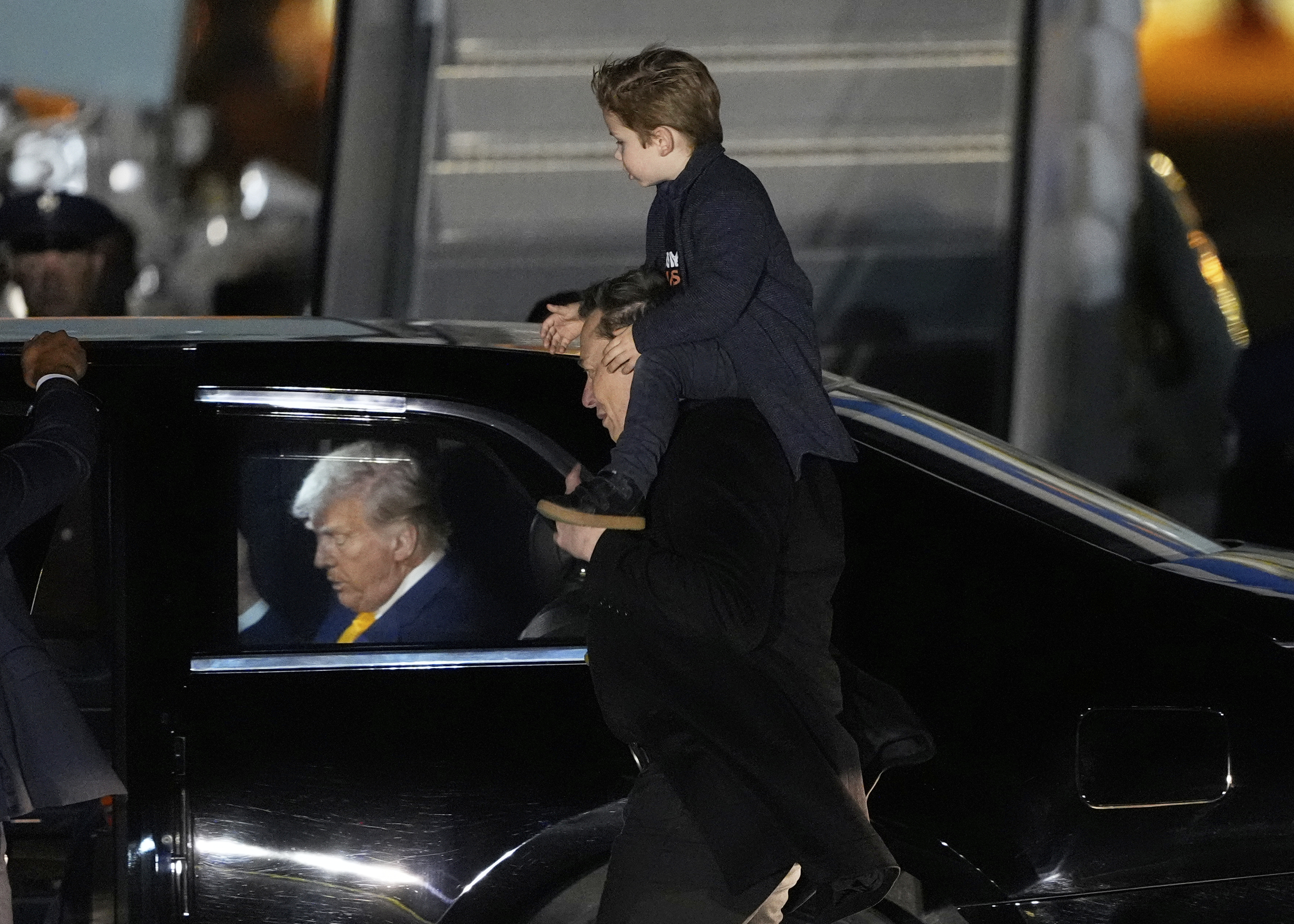 FILE - Elon Musk carries his son X Æ A-Xii as they arrives on Air Force One with President Donald Trump, left, at Miami International Airport, April 12, 2025, in Miami, Fla. (AP Photo/Manuel Balce Ceneta, File)