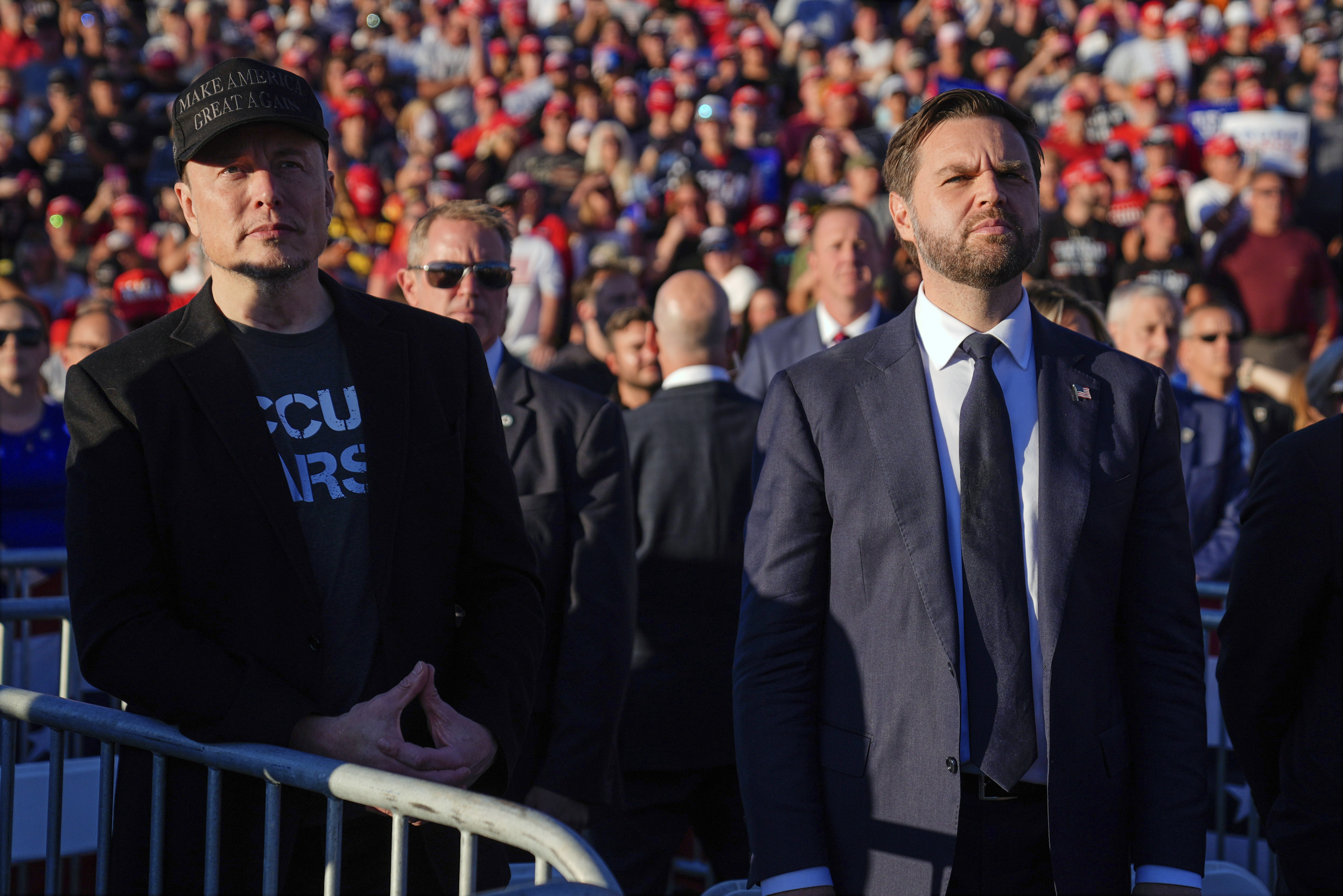 FILE - Elon Musk, left, and Republican vice presidential nominee Sen. JD Vance, R-Ohio, listen as Republican presidential nominee former President Donald Trump speaks at a campaign rally, Oct. 5, 2024, in Butler, Pa. (AP Photo/Evan Vucci, File)