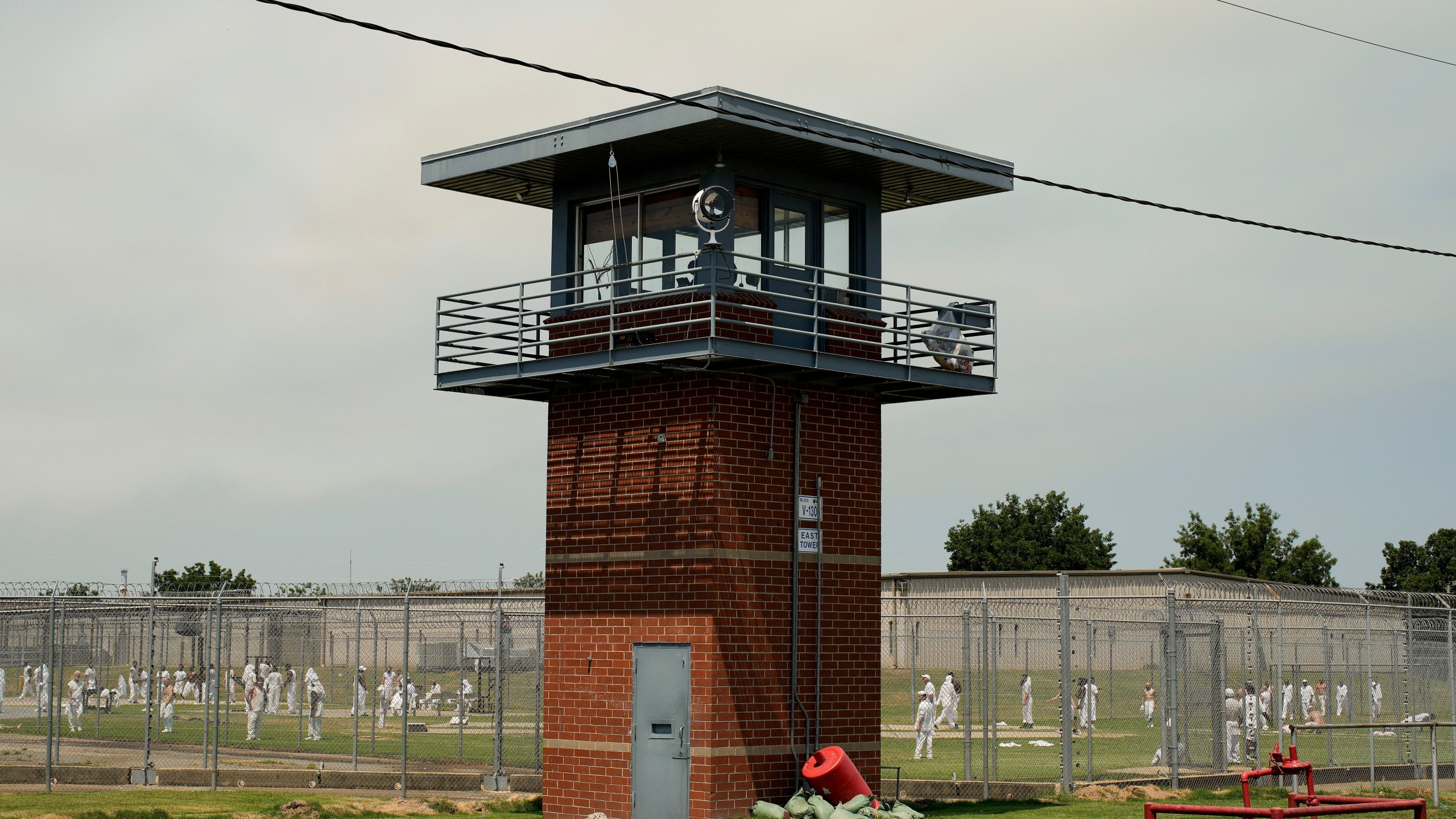 FILE - Prisoners walk through a yard at the Varner Unit of Arkansas' Department of Corrections, Friday, Aug. 18, 2023, in Gould, Ark. (AP Photo/John Locher, File)