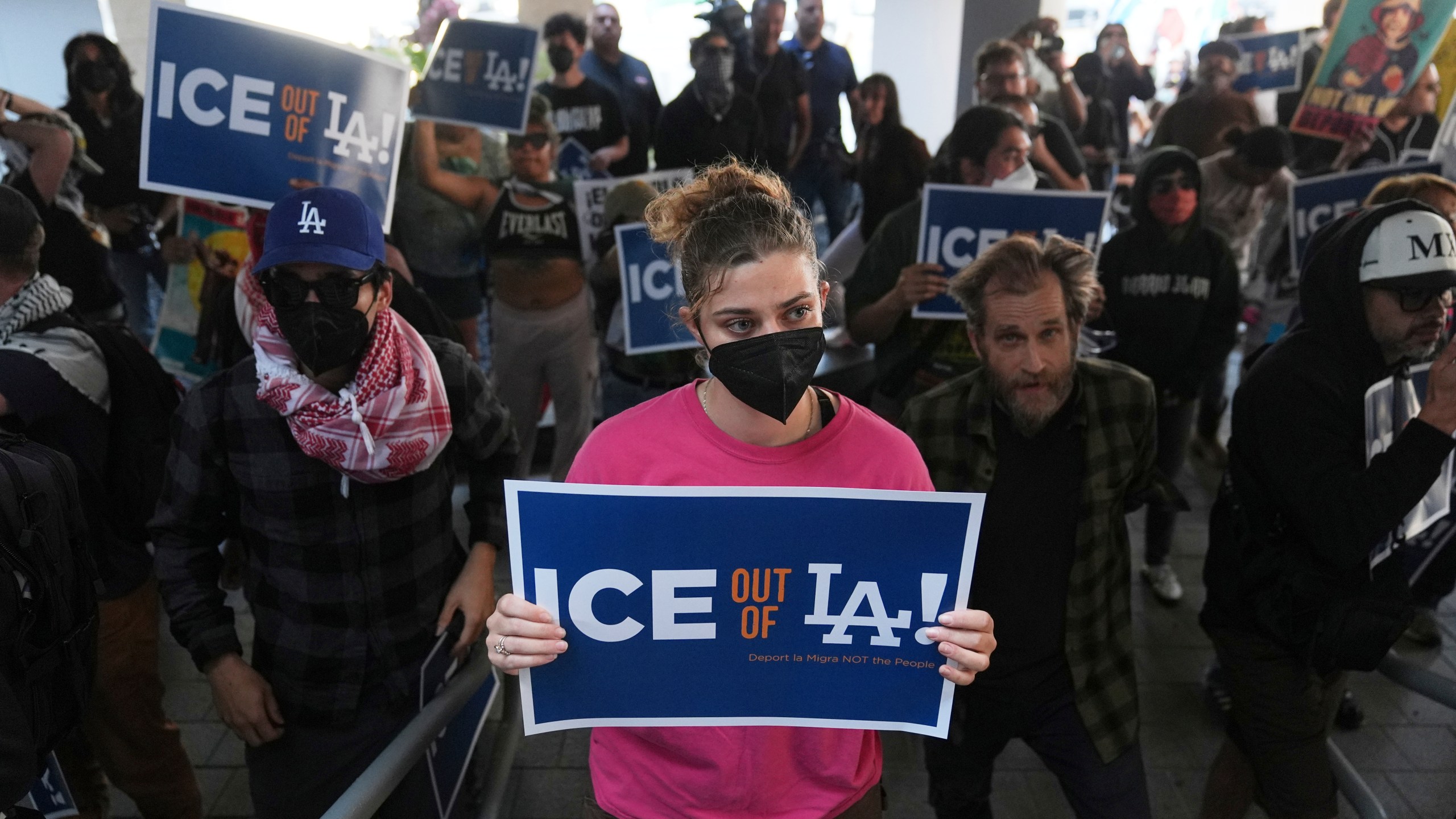 Protesters gather at the U.S. Department of Justice Federal Bureau of Prisons after federal immigration authorities conducted an operation on Friday, June 6, 2025, in Los Angeles. (AP Photo/Jae C. Hong)