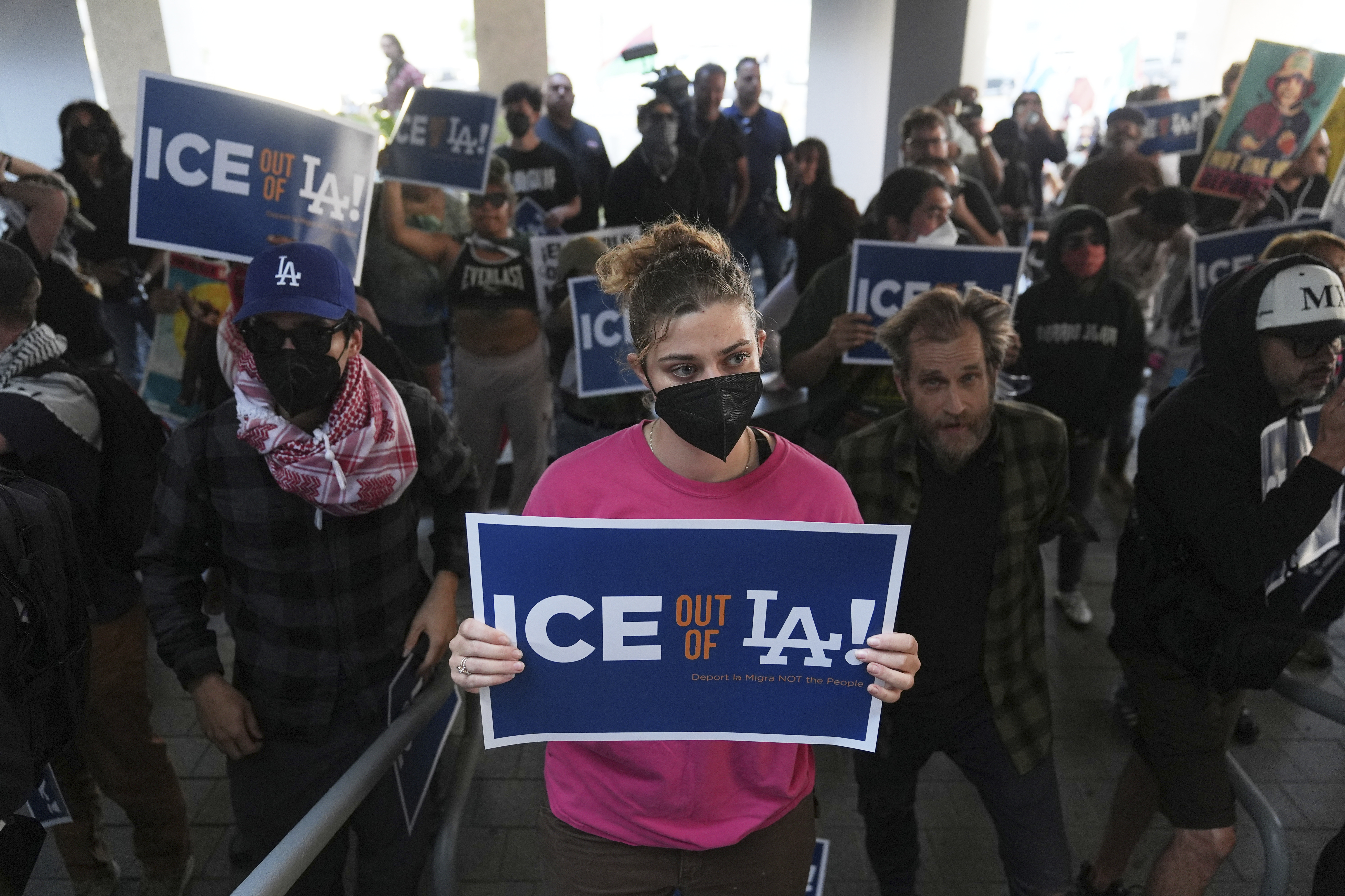 Protesters gather at the U.S. Department of Justice Federal Bureau of Prisons after federal immigration authorities conducted an operation on Friday, June 6, 2025, in Los Angeles. (AP Photo/Jae C. Hong)