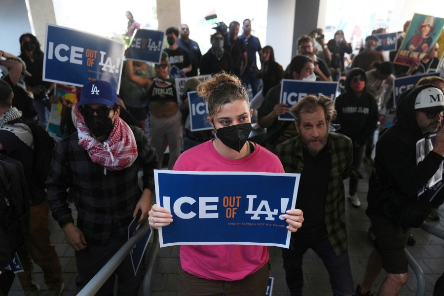 Protesters gather at the U.S. Department of Justice Federal Bureau of Prisons after federal immigration authorities conducted an operation on Friday, June 6, 2025, in Los Angeles. (AP Photo/Jae C. Hong)