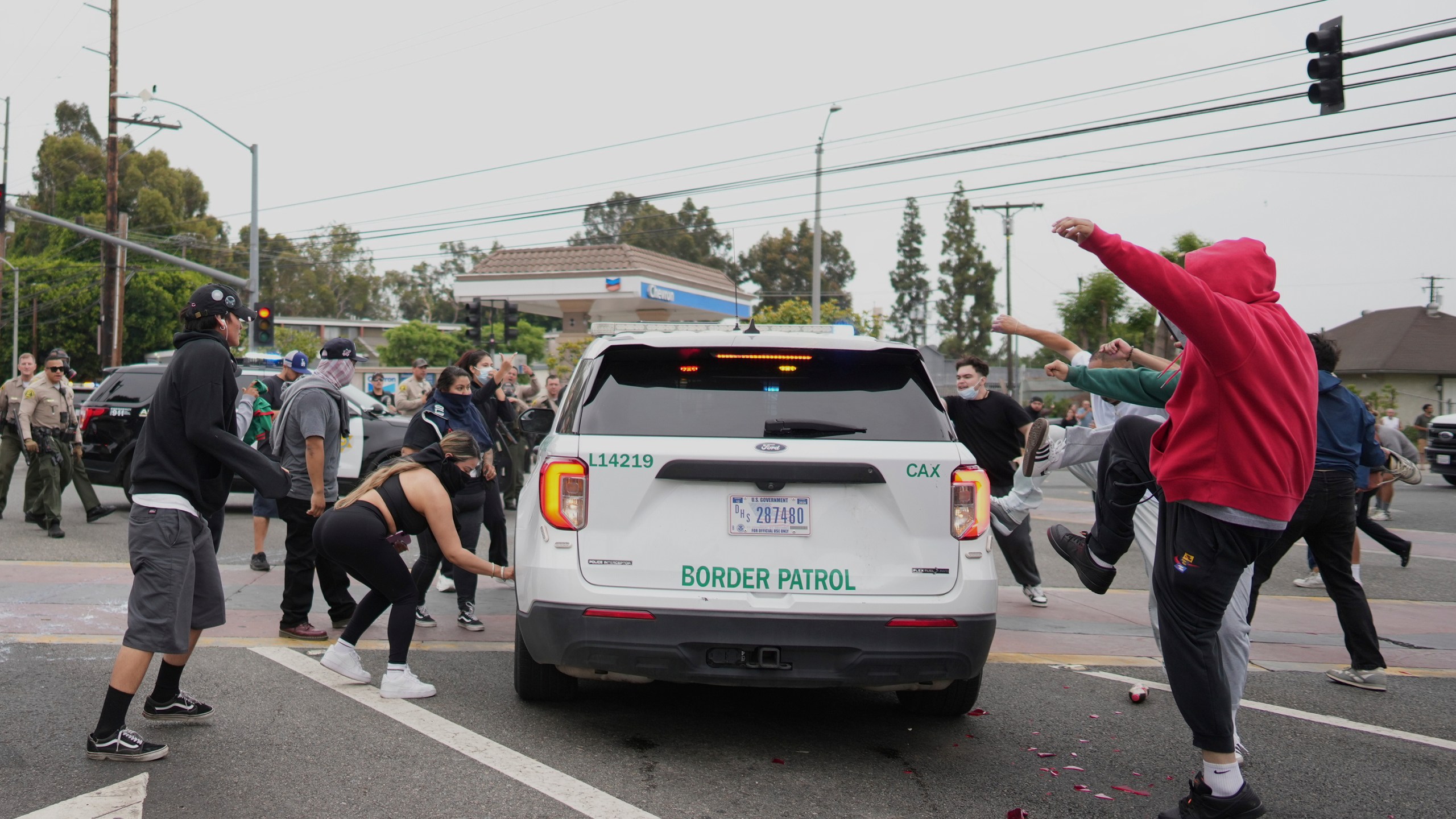 Protesters kick the side of a Border Patrol vehicle during a demonstration over the dozens detained in an operation by federal immigration authorities a day earlier, in Paramount, Calif., Saturday, June 7, 2025. (AP Photo/Eric Thayer)