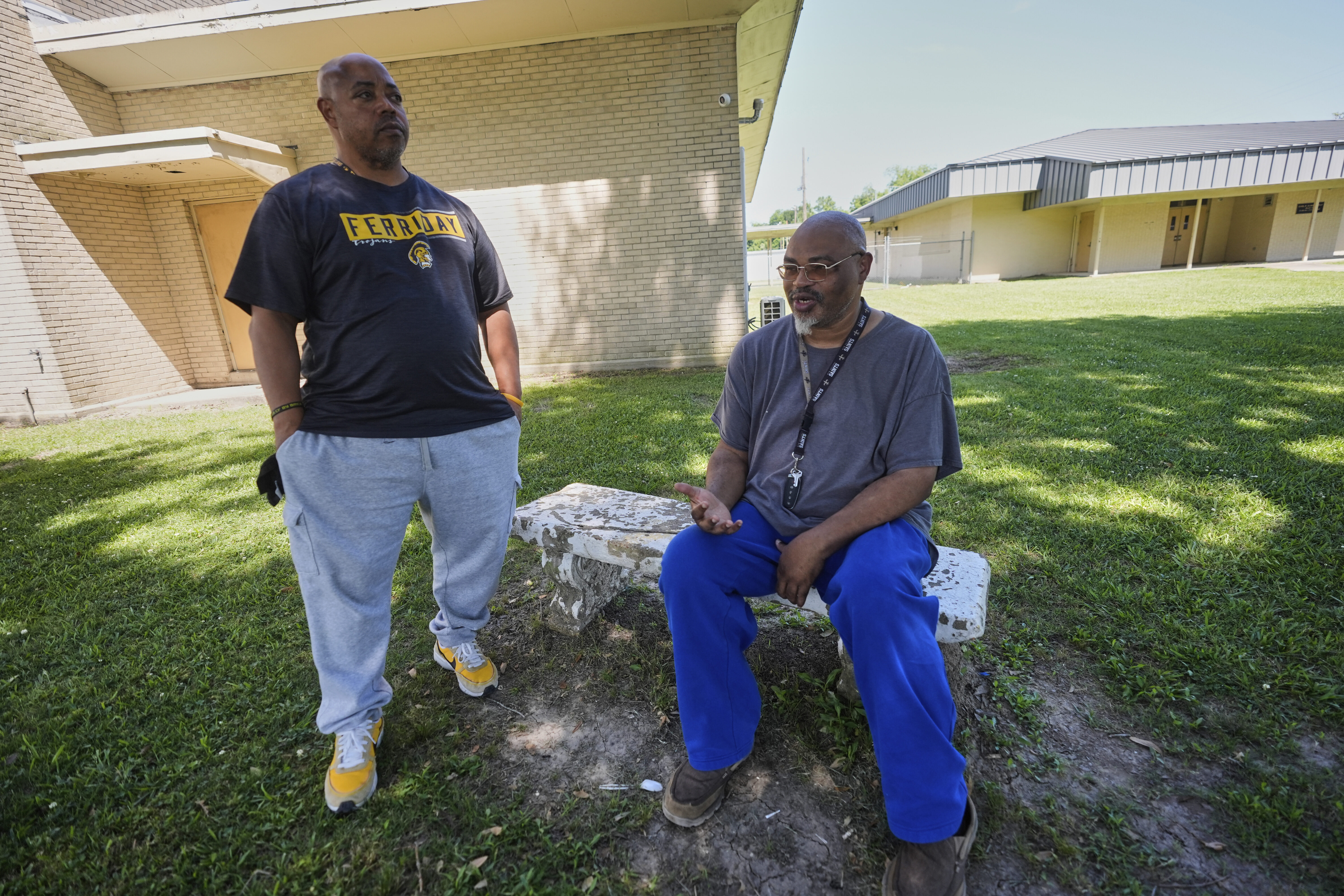 Alumnus Brian Davis, right, and assistant football coach Derrick Davis talk outside Ferriday High School in Ferriday, La., Thursday, May 22, 2025. (AP Photo/Gerald Herbert)
