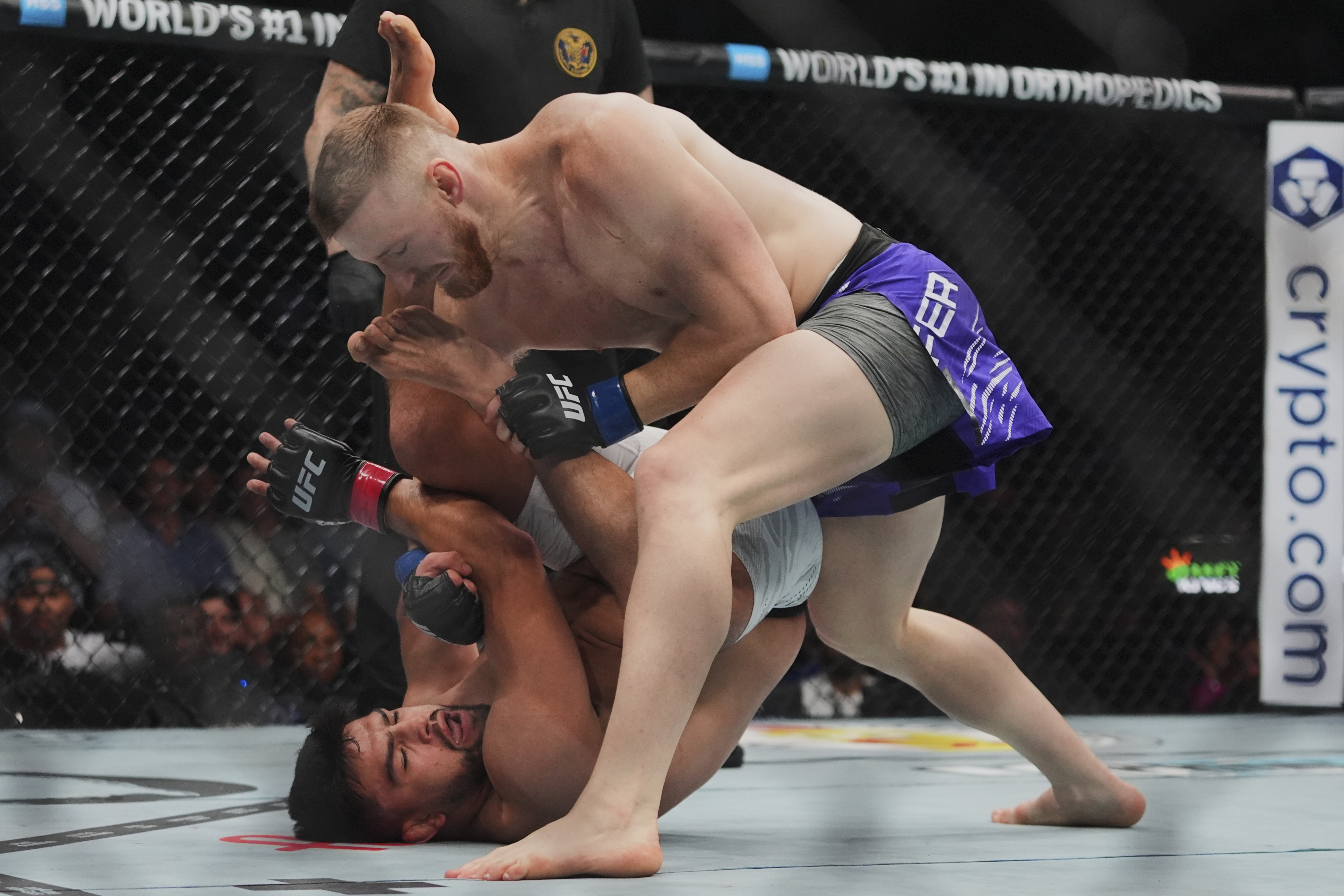 Joe Pyfer, right, punches Kelvin Gastelumduring the first round of a middleweight bout at the UFC 316 mixed martial arts event Saturday, June 7, 2025 in Newark, N.J. (AP Photo/Frank Franklin II)