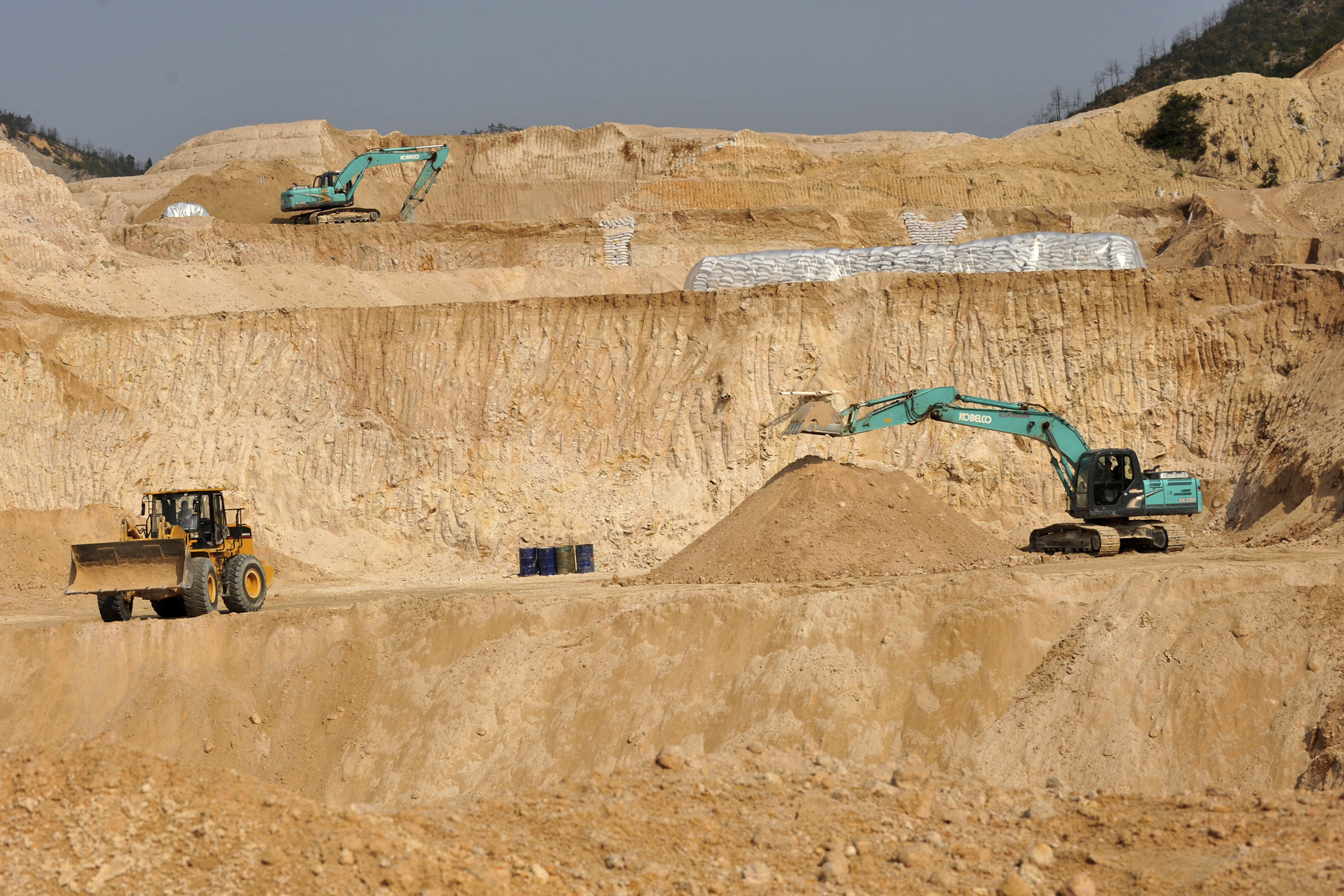 FILE - Workers use machinery to dig at a rare earth mine in Ganxian county in central China's Jiangxi province on Dec. 30, 2010. (Chinatopix via AP, File)