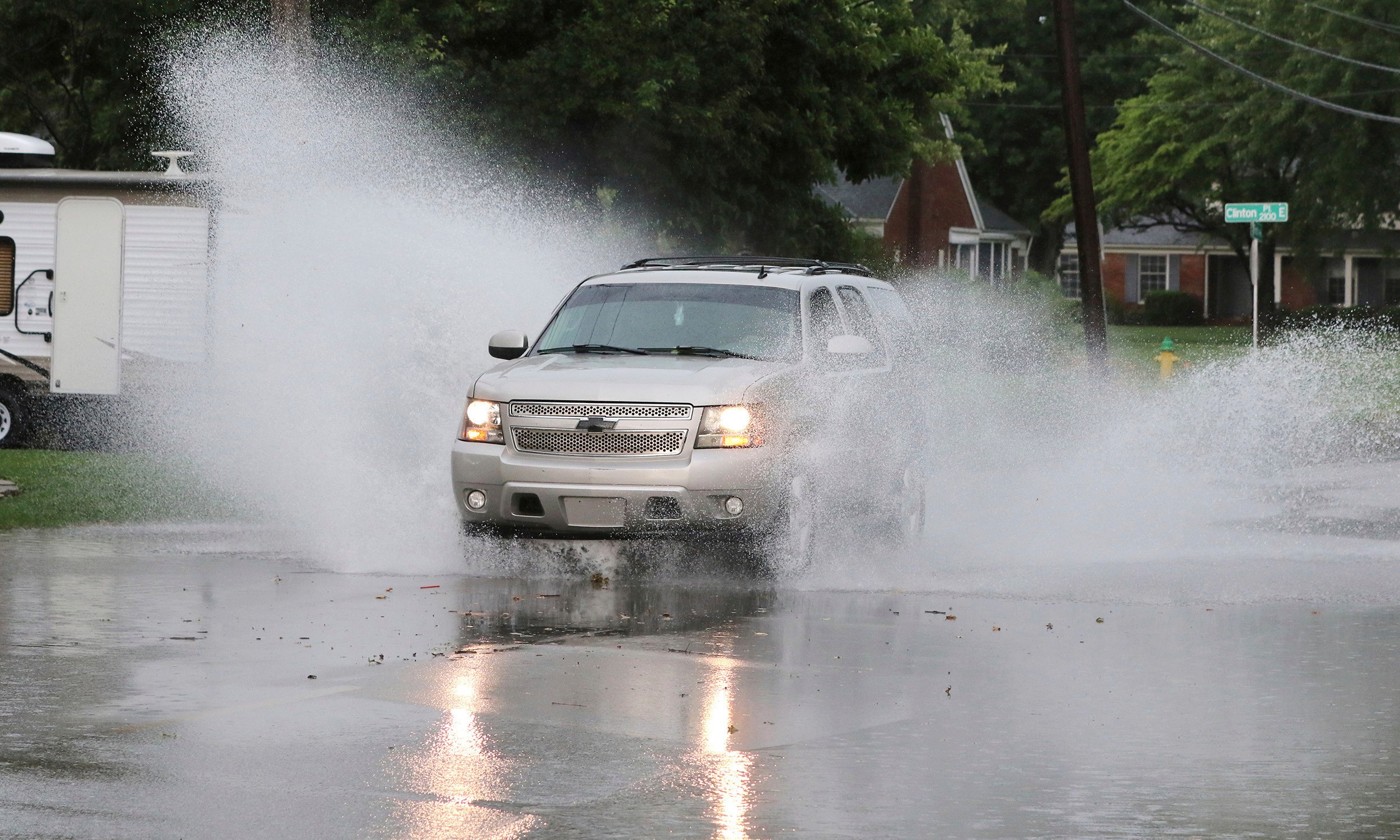 A motorist drives through some standing water along the 2100 block of Ford Avenue during the storm that hit on Friday afternoon in Owensboro, Ky. on June 6, 2025. (Alan Warren/The Messenger-Inquirer via AP)