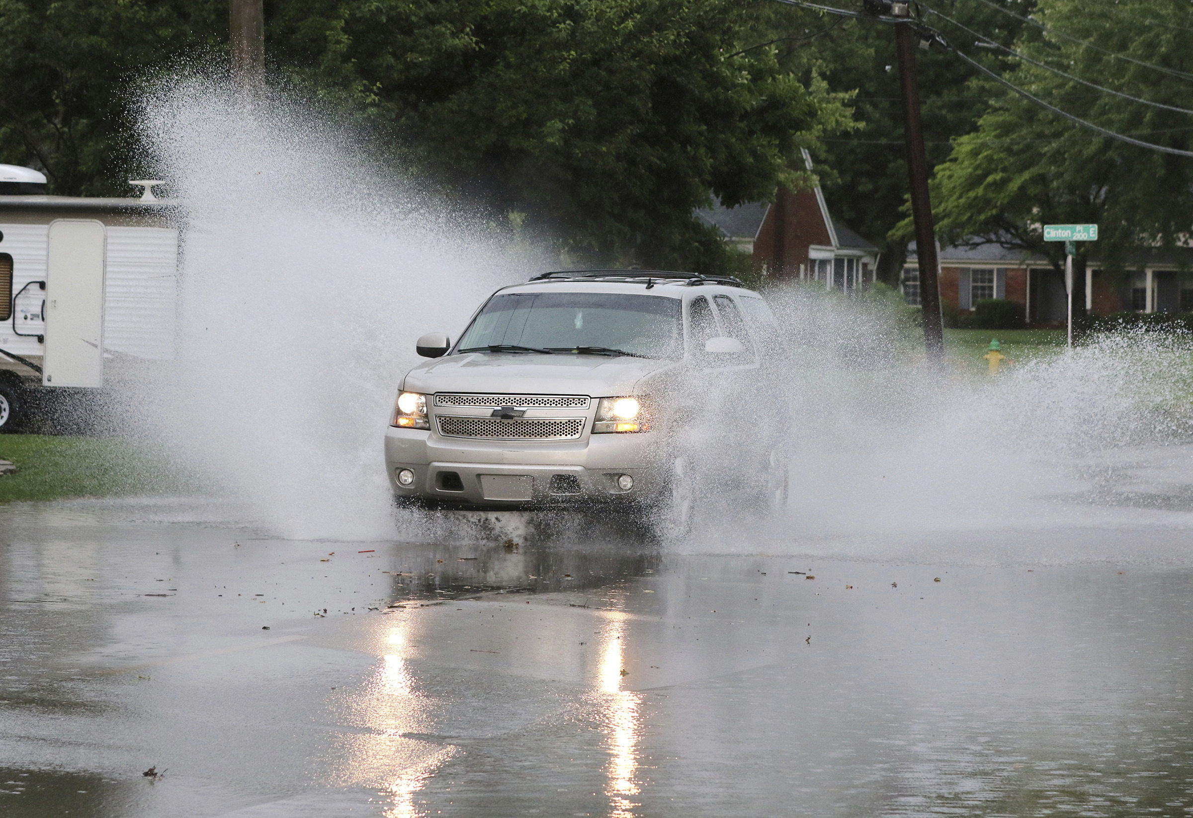 A motorist drives through some standing water along the 2100 block of Ford Avenue during the storm that hit on Friday afternoon in Owensboro, Ky. on June 6, 2025. (Alan Warren/The Messenger-Inquirer via AP)