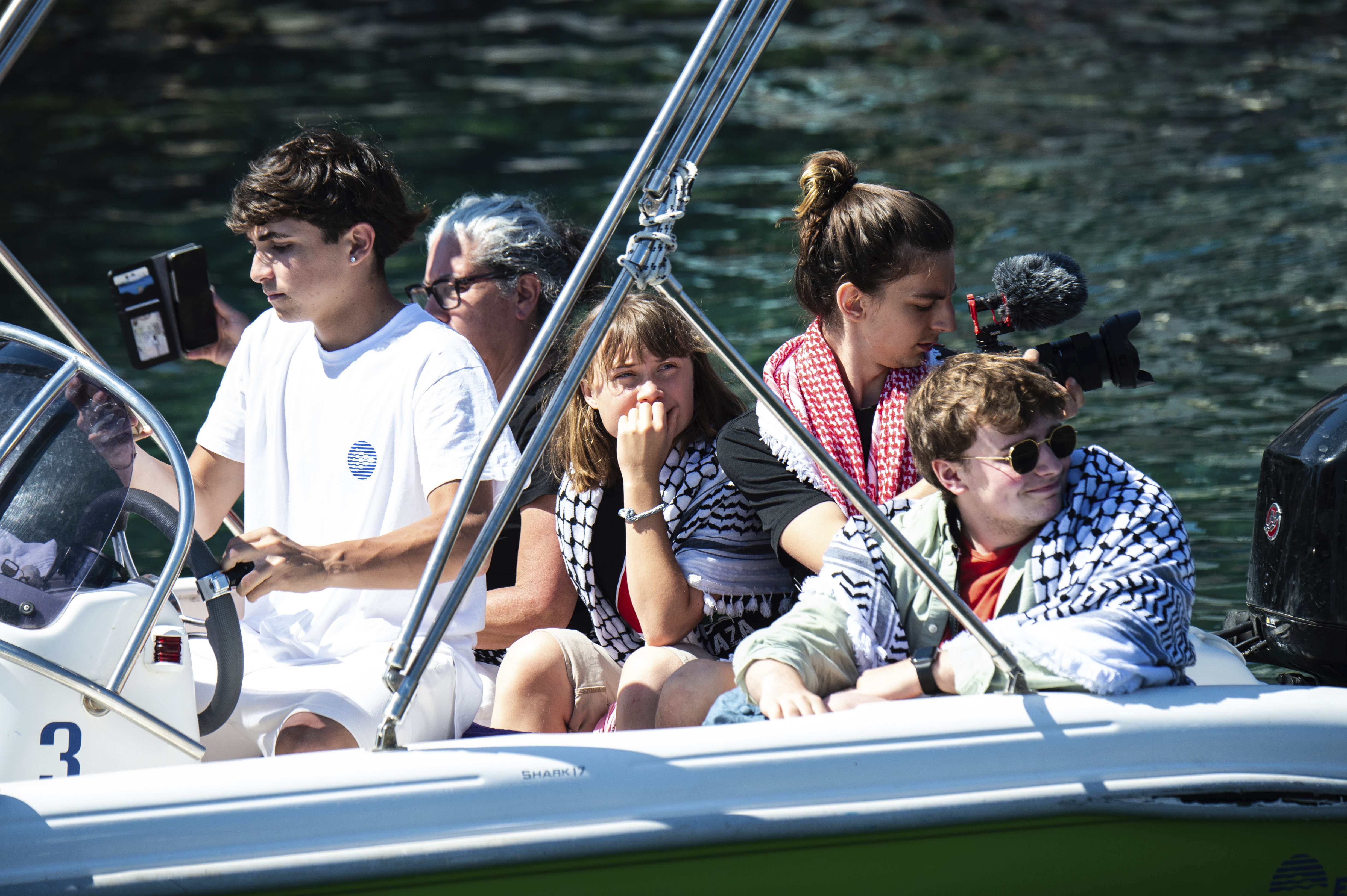 Climate activist Greta Thunberg, center, waits to board the Madleen boat, before setting sail for Gaza along with activists of the Freedom Flotilla Coalition, departing from the Sicilian port of Catania, Italy, Sunday, June 1, 2025. (AP Photo/Salvatore Cavalli)