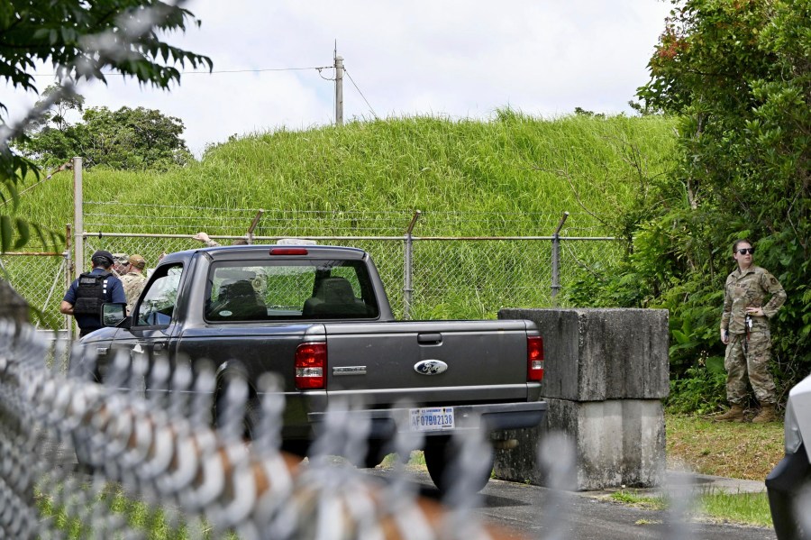 U.S. military persons gather near the site of an explosion at a storage site for unexploded ordnances at a U.S. military base in the town of Yomitanson, Okinawa prefecture, southern Japan Monday, June 9, 2025. (Kyodo News via AP)