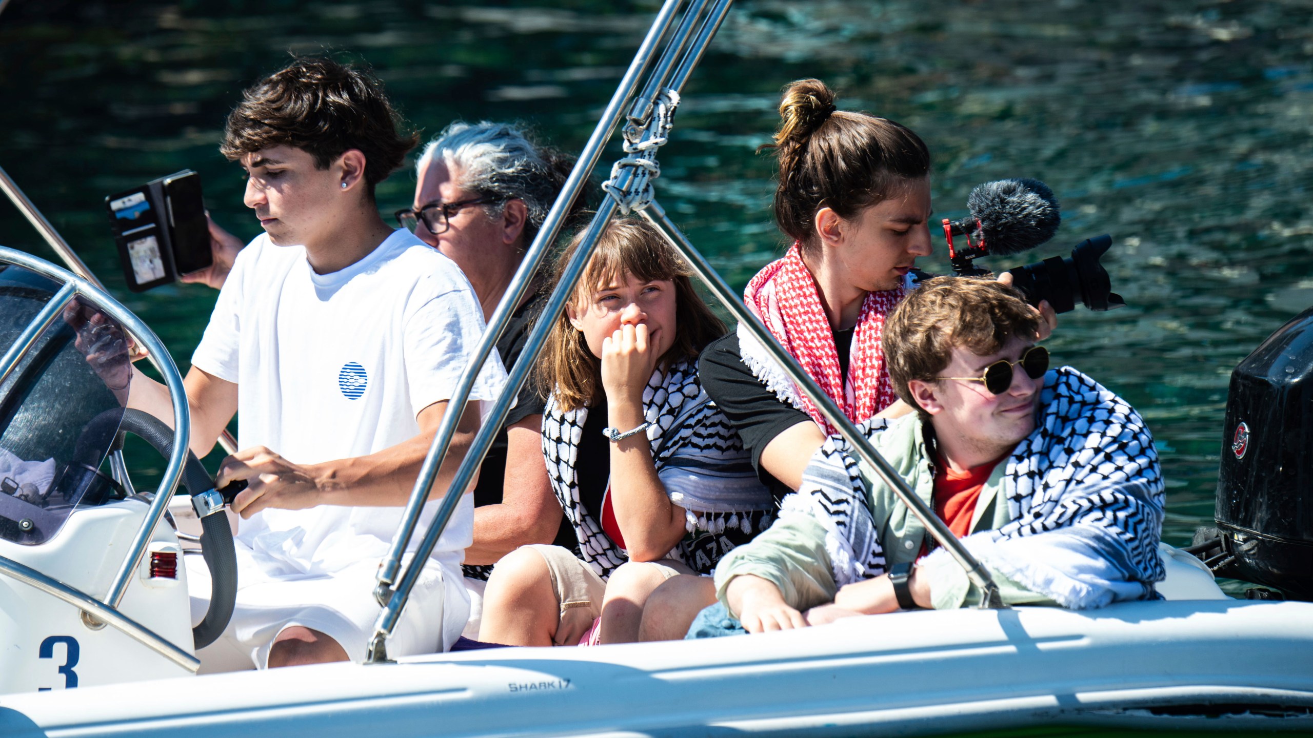 Climate activist Greta Thunberg, center, waits to board the Madleen boat, before setting sail for Gaza along with activists of the Freedom Flotilla Coalition, departing from the Sicilian port of Catania, Italy, Sunday, June 1, 2025. (AP Photo/Salvatore Cavalli)