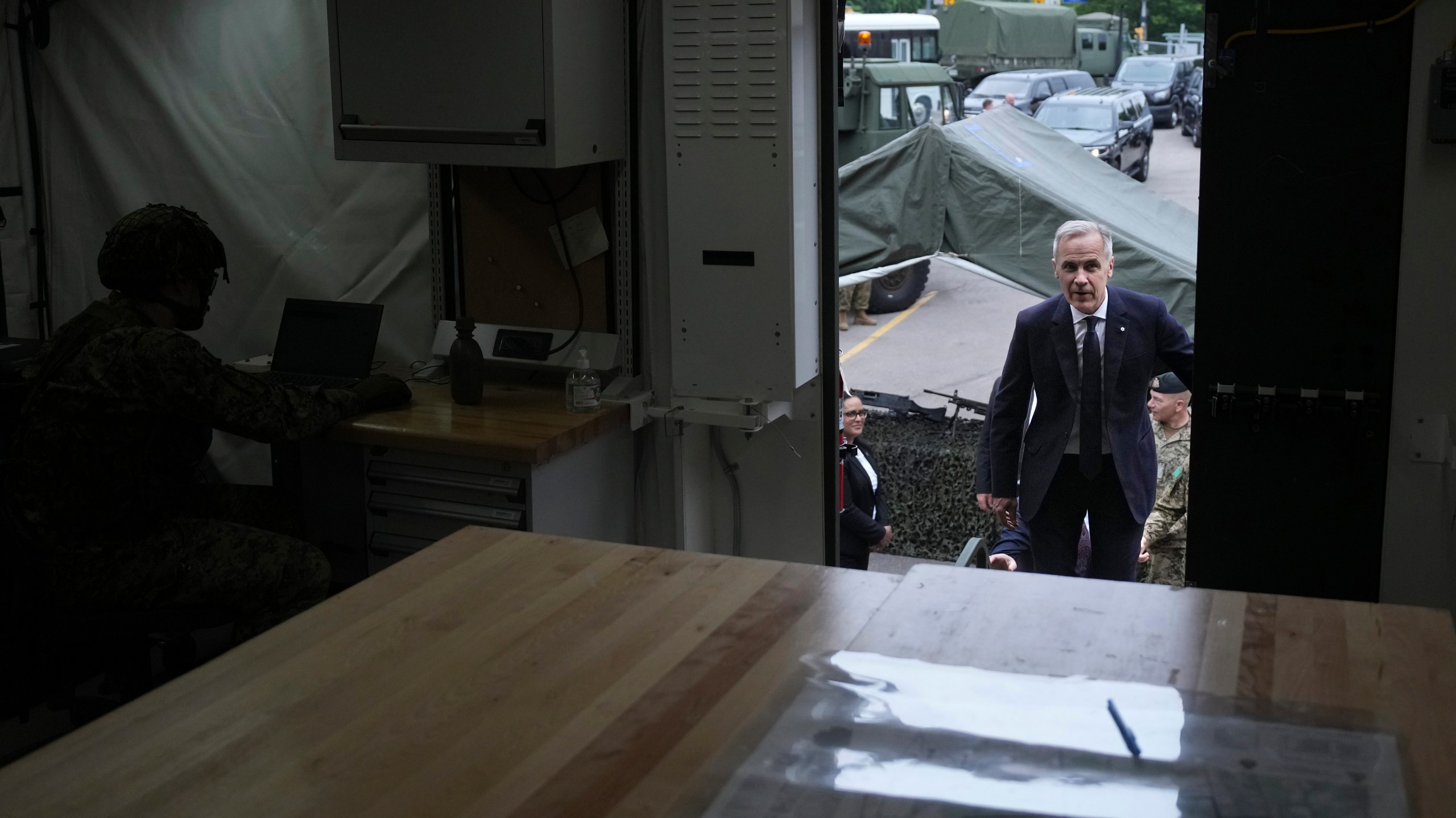 Canada Prime Minister Mark Carney steps into a command post as he visits Fort York Armoury in Toronto, Canada, before making an announcement on Monday, June 9, 2025. (Chris Young/The Canadian Press via AP)