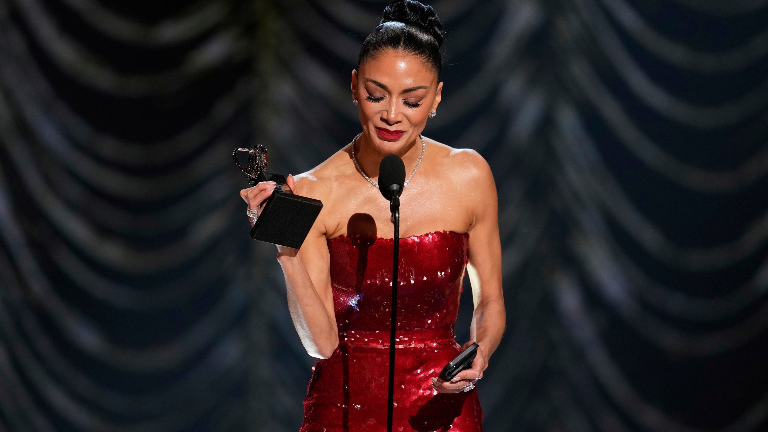 Nicole Scherzinger accepts the award for best performance by an actress in a leading role in a musical for "Sunset Blvd." during the 78th Tony Awards on Sunday, June 8, 2025, at Radio City Music Hall in New York. (Photo by Charles Sykes/Invision/AP)