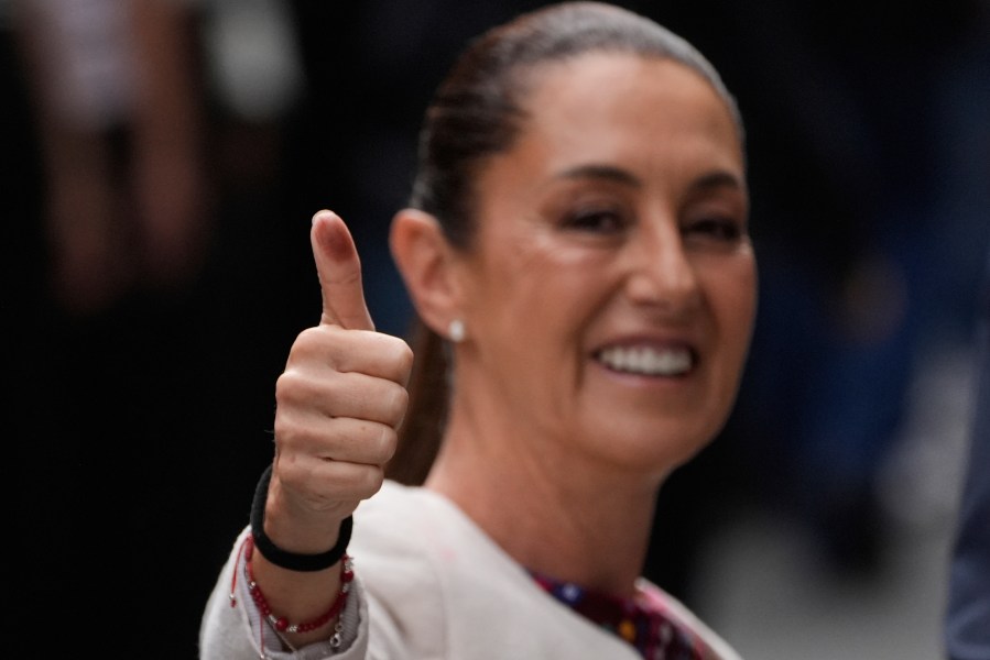President Claudia Sheinbaum shows her inked thumb after voting in the country's first judicial elections in Mexico City, June 1, 2025. (AP Photo/Marco Ugarte)