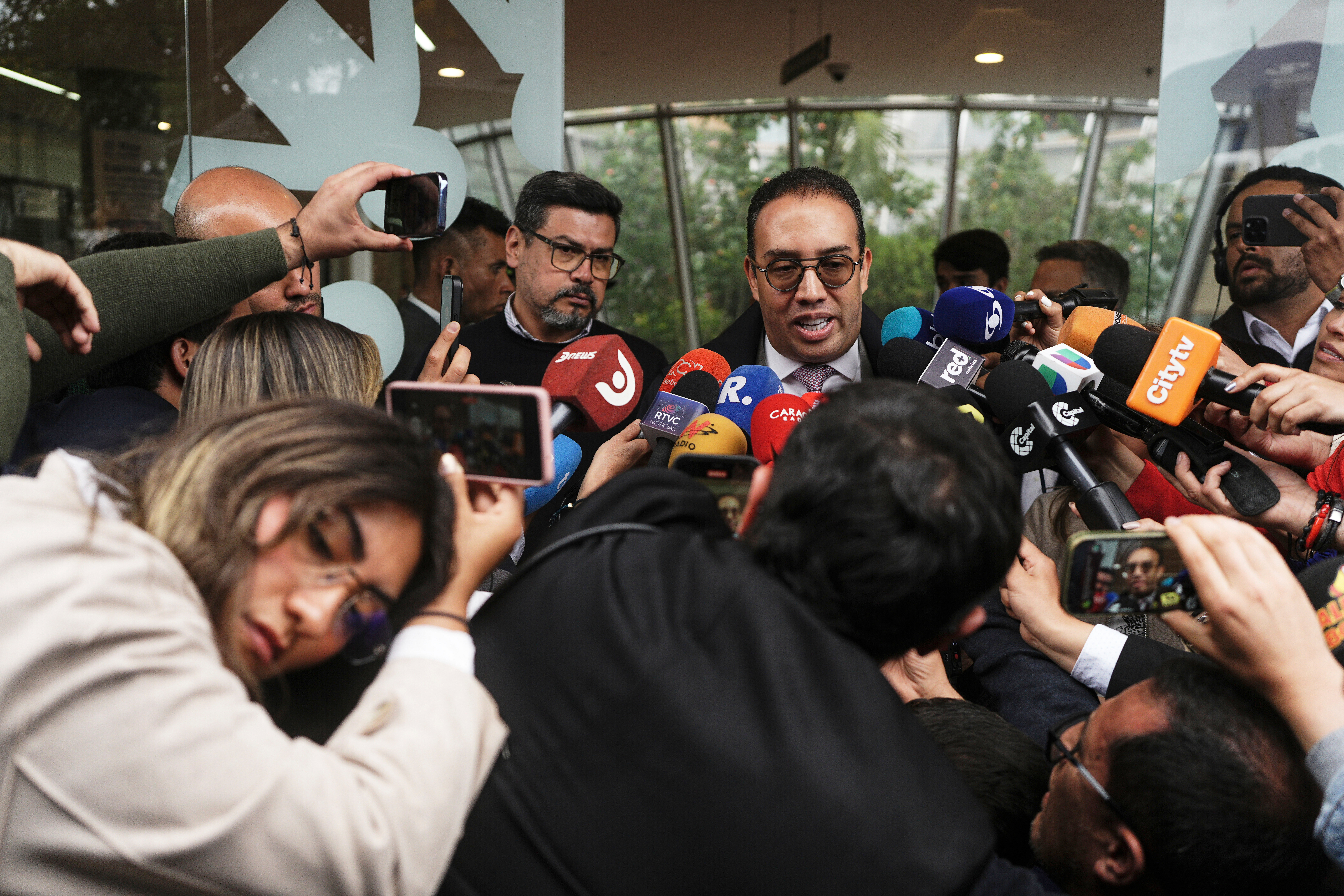 Lawyer Victor Mosquera, representative of Senator Miguel Uribe Turbay, talks outside the clinic where the Colombian Senator is being treated after he was shot at a political rally in Bogota, Colombia, Monday, June 9, 2025. (AP Photo/Ivan Valencia)