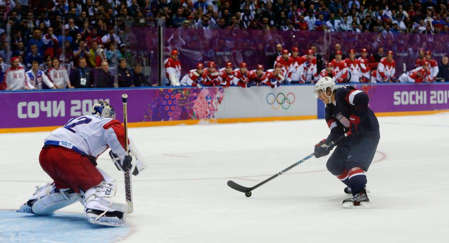 FILE - USA forward T.J. Oshie prepares to take a shot against Russia goaltender Sergei Bobrovski in an overtime shootout during a men's ice hockey game at the 2014 Winter Olympics, Saturday, Feb. 15, 2014, in Sochi, Russia. Oshie scored the winning goal and the USA won 3-2. (AP Photo/Julio Cortez, File)