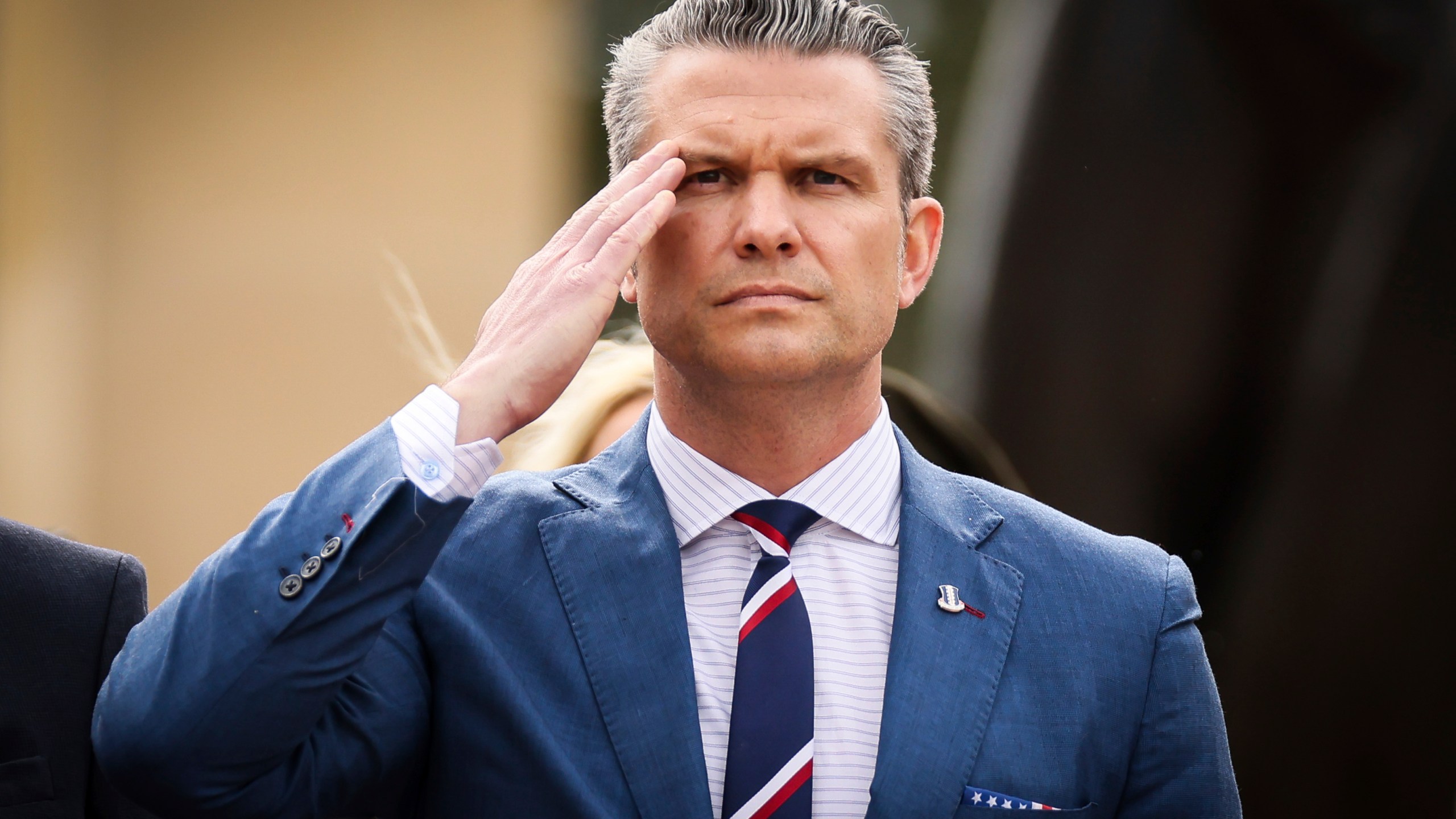 U.S. Defense Secretary Pete Hegseth salutes during a ceremony at the US cemetery to commemorate the 81st anniversary of the D-Day landings, Friday, June 6, 2025 in Colleville-sur-Mer, Normandy. (AP Photo/Thomas Padilla)