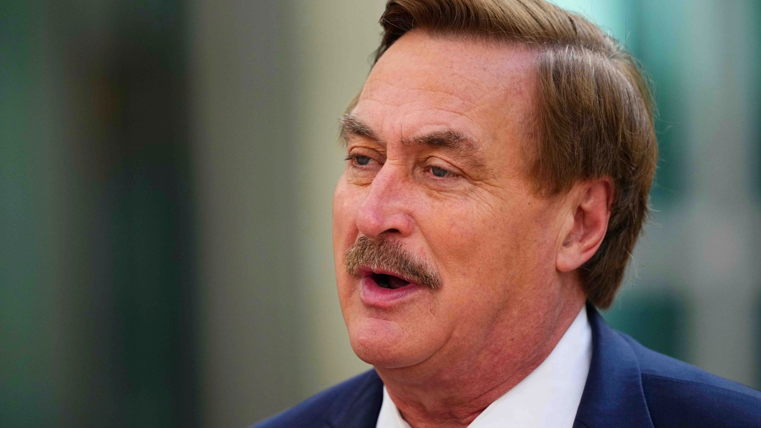Mike Lindell talks to the media on his way into federal district court for a defamation trial on Thursday, June 5, 2025, in Denver. (AP Photo/Jack Dempsey)
