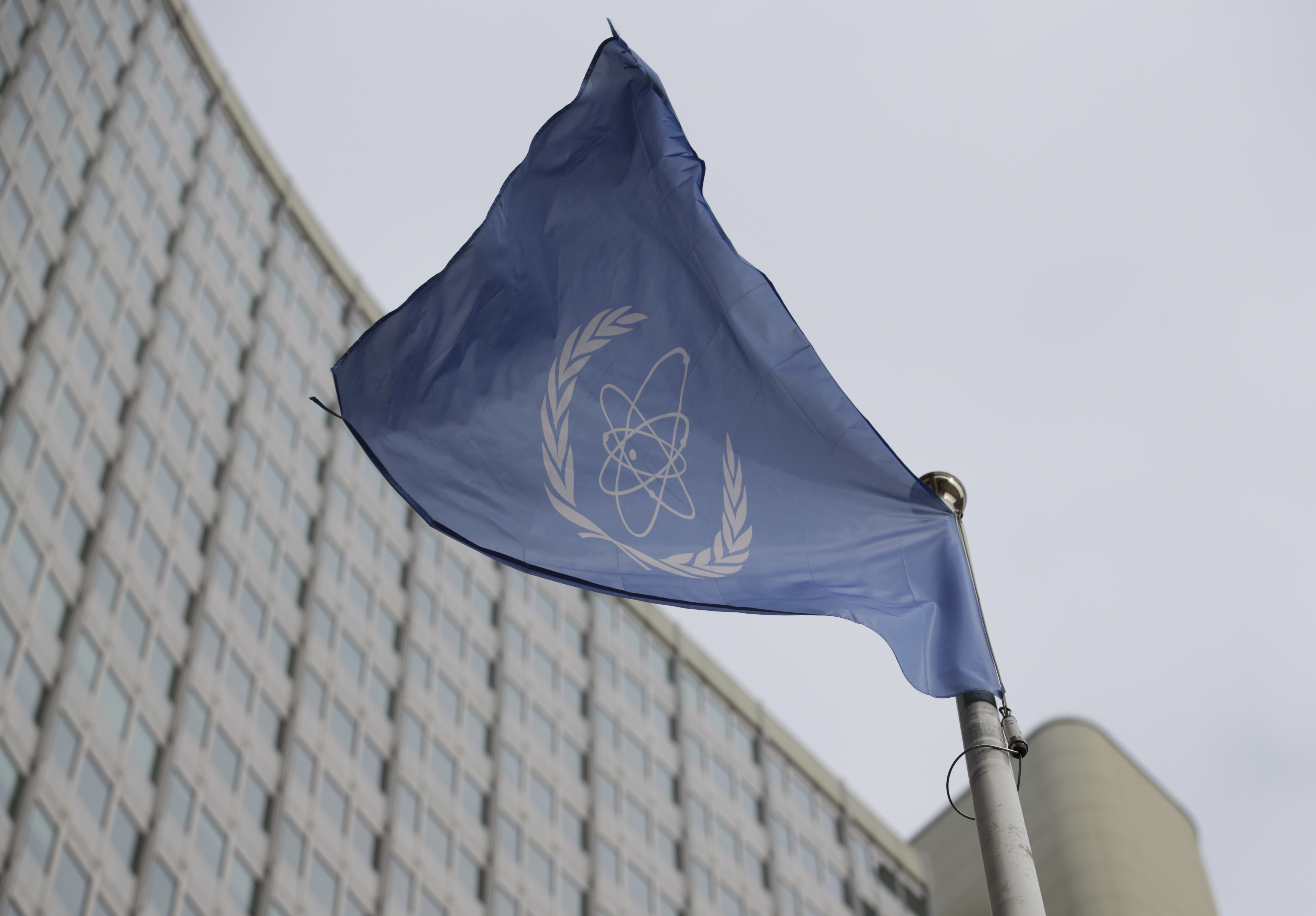 FILE - The flag of the International Atomic Energy Agency flys in front of its headquarters during an IAEA Board of Governors meeting in Vienna, Austria, Feb. 6, 2023. (AP Photo/Heinz-Peter Bader, File)