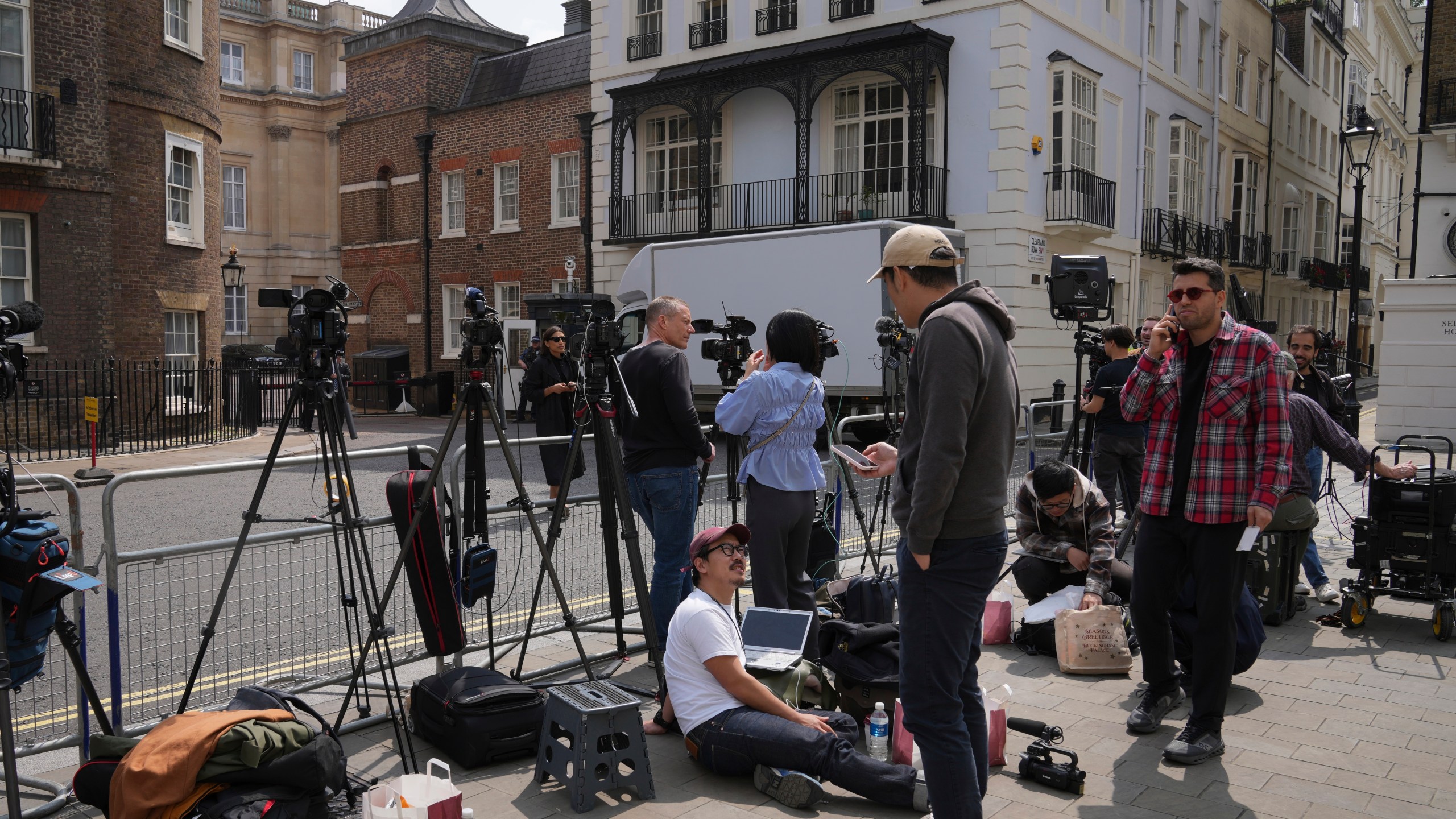 Reporters wait at the entrance of Lancaster House, where the trade talks between the U.S. and China are taking place, in London, Monday, June 9, 2025. (AP Photo/Kin Cheung)