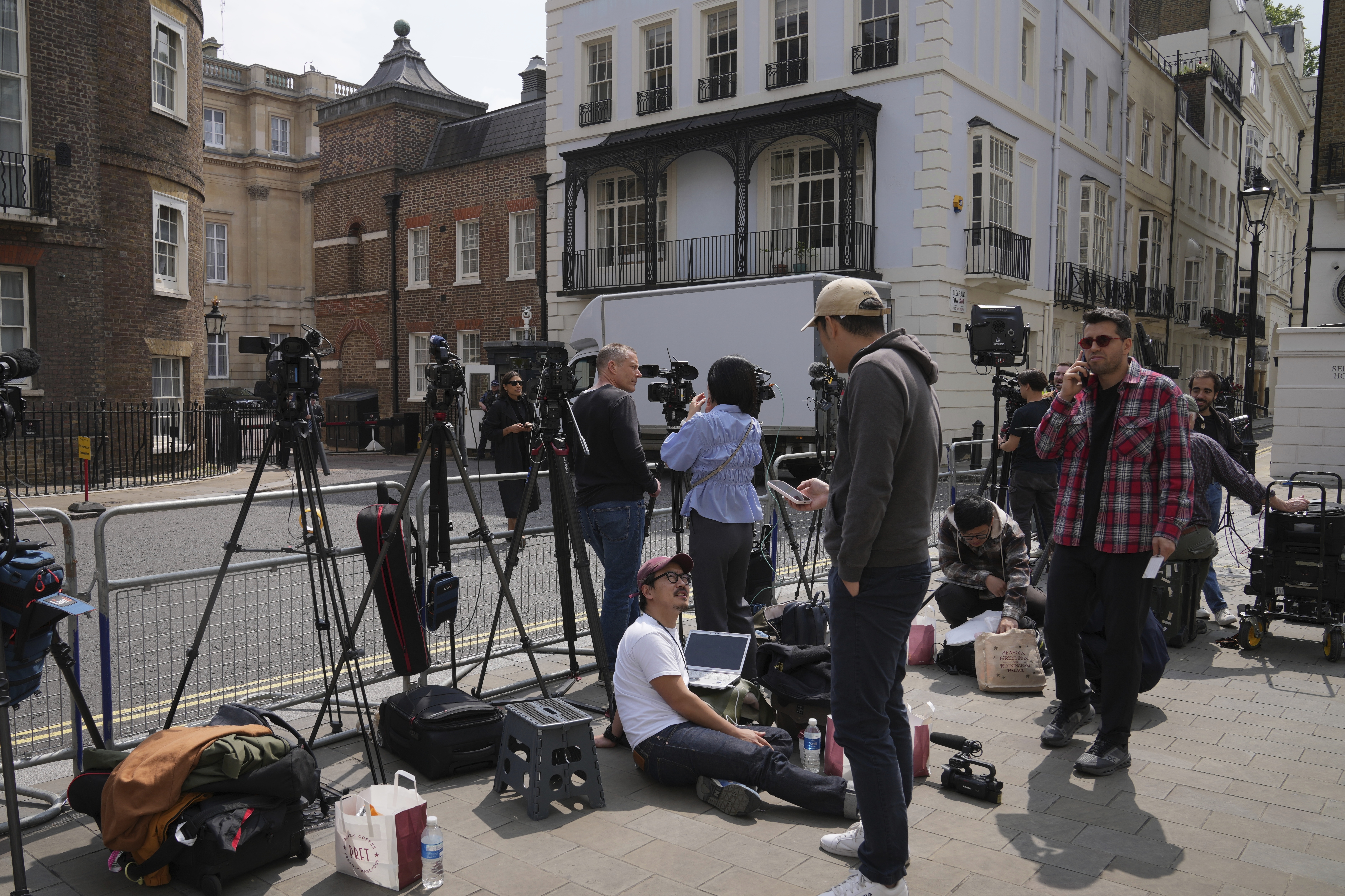 Reporters wait at the entrance of Lancaster House, where the trade talks between the U.S. and China are taking place, in London, Monday, June 9, 2025. (AP Photo/Kin Cheung)