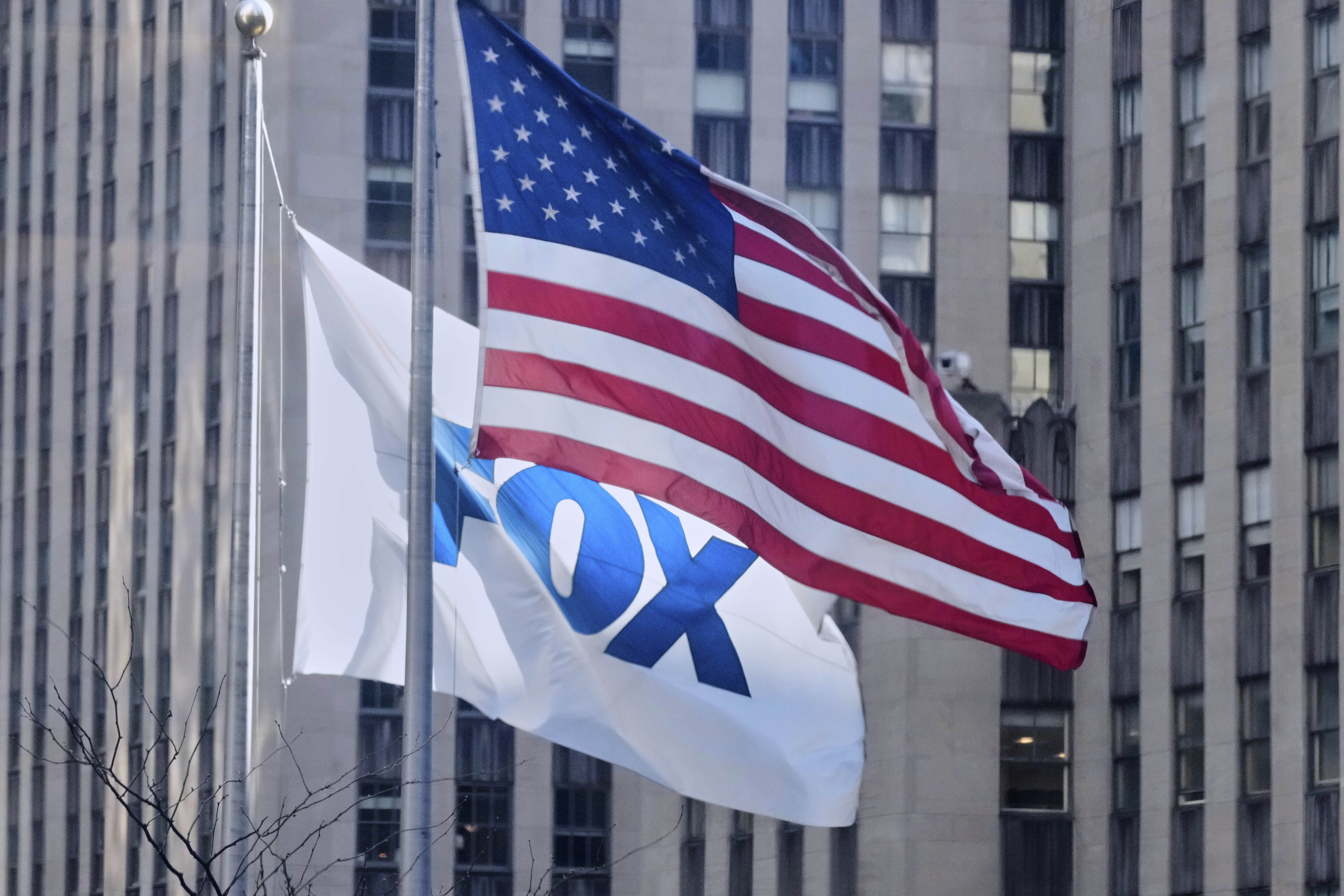 FILE - An American flag and a FOX flag fly outside Fox headquarters, in New York, April 9, 2025. (AP Photo/Richard Drew, File)