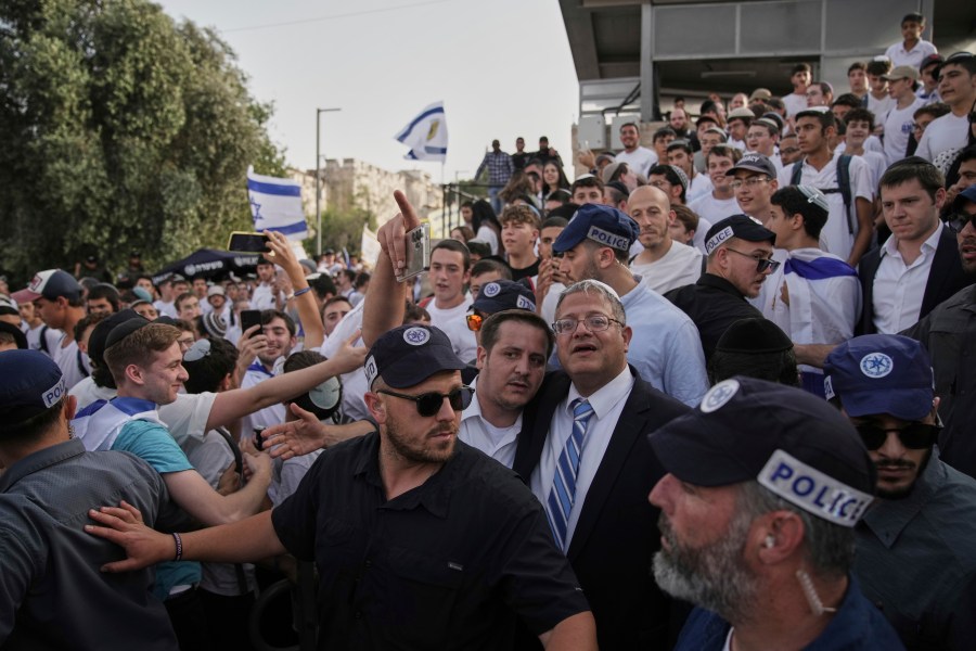 Surrounded by security guards, Israel's far-right National Security Minister, Itamar Ben-Gvir, center, participates in march marking Jerusalem Day, an Israeli holiday celebrating the capture of east Jerusalem in the 1967 Mideast war, in Damascus Gate of Jerusalem's Old City, Monday, May 26, 2025. (AP Photo/Leo Correa)