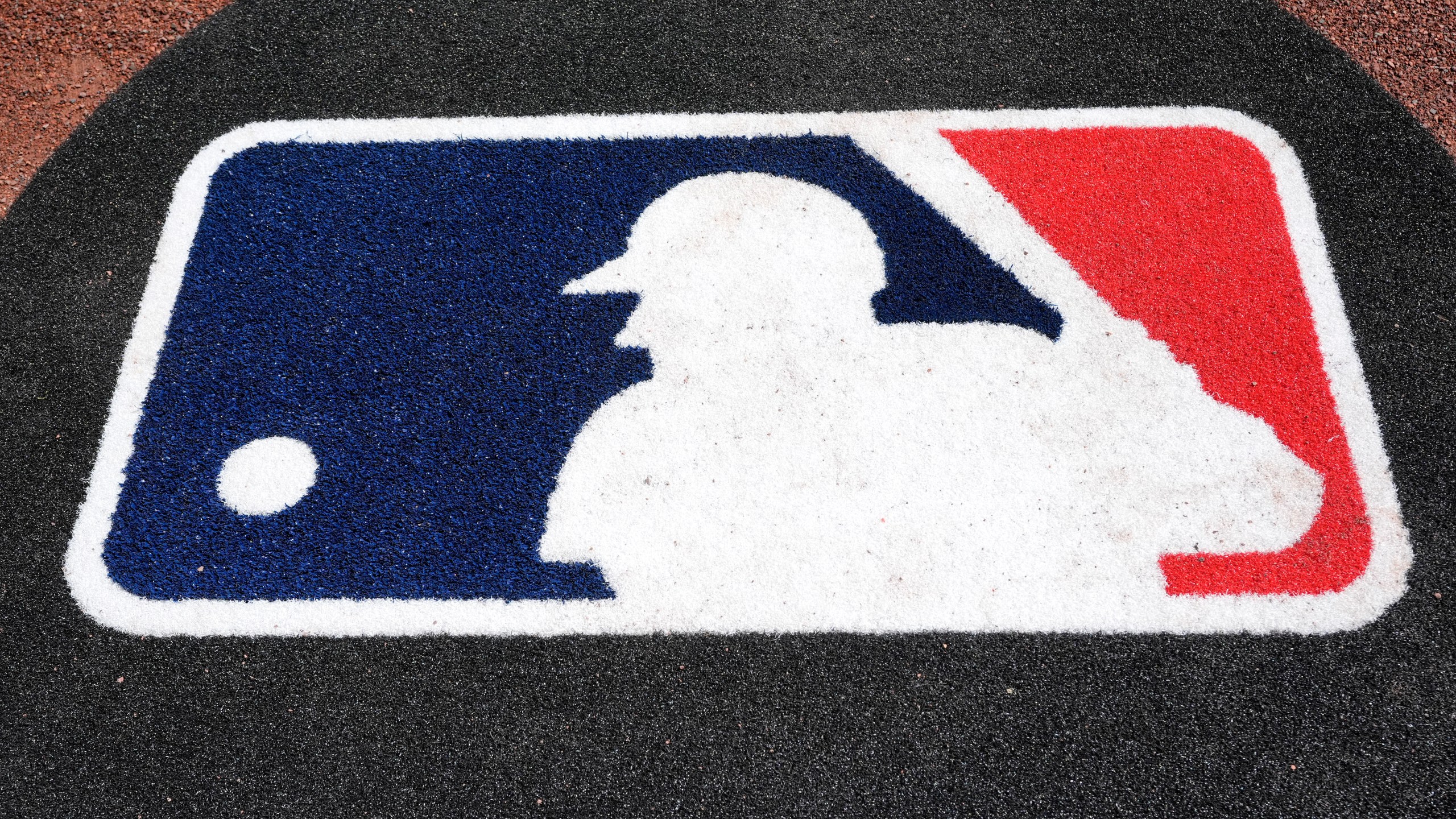 FILE - The Major League Baseball logo is seen on the field before a spring training baseball game between the Pittsburgh Pirates and the Atlanta Braves Tuesday, Feb. 27, 2024, in Bradenton, Fla. (AP Photo/Charlie Neibergall, file)