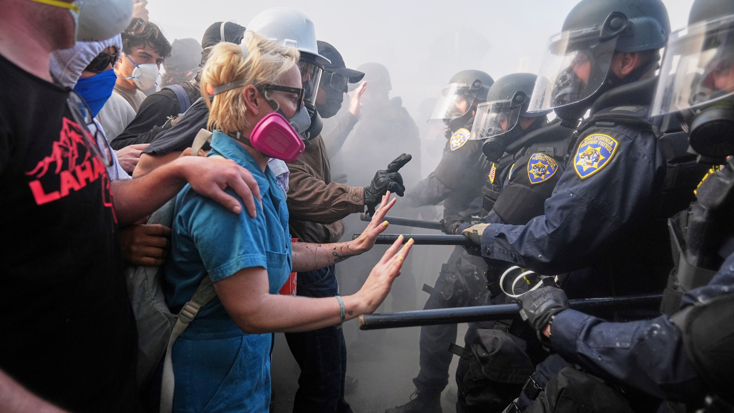 FILE - Protesters confront police on the 101 Freeway near the Metropolitan Detention Center in downtown Los Angeles, Sunday, June 8, 2025, following last night's immigration raid protest. (AP Photo/Jae C. Hong, File)