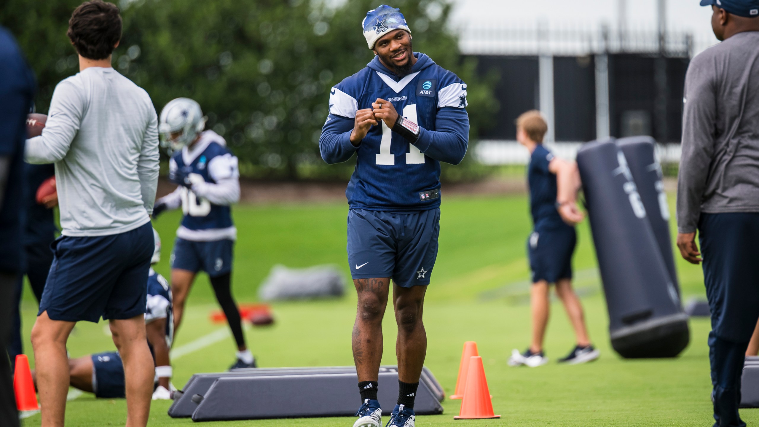 Dallas Cowboys' Micah Parsons talks to a coach during NFL football practice at the Cowboys facility, Tuesday, June 10, 2025, in Frisco, Texas. (AP Photo/Jessica Tobias)